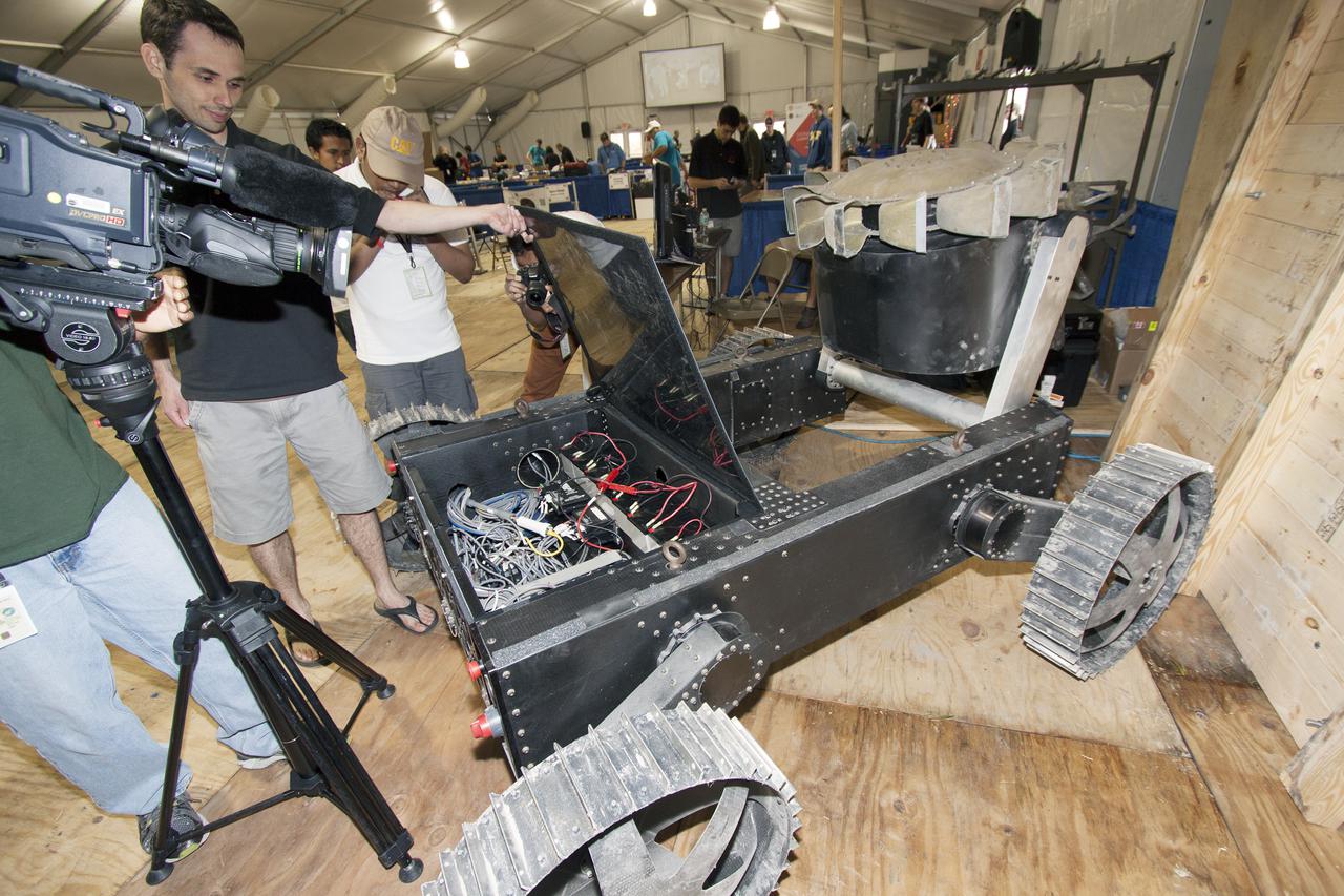 CAPE CANAVERAL, Fla. – A team from Astrobotic Technology, Inc., demonstrates the Polaris rover at a robotics mining competition at NASA's Kennedy Space Center. Astrobotic developed the Polaris to prospect water at the lunar poles. Photo credit: Jim Grossmann