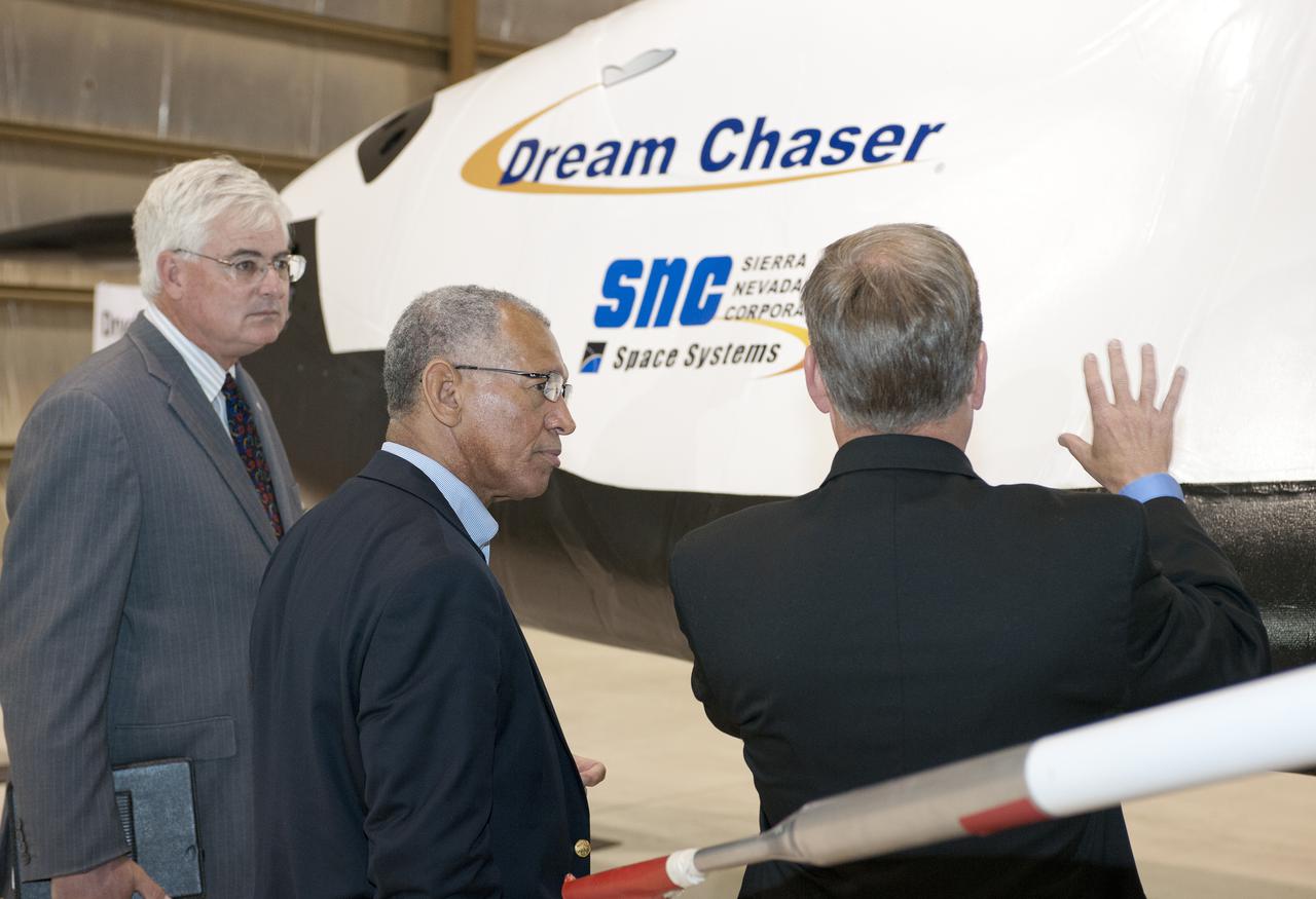 Edwards, Calif. – ED-0155-12 - Steve Lindsey, Sierra Nevada Corporation, or SNC, director of flight operations and former space shuttle astronaut, right, talks to NASA Administrator Charlie Bolden, center, and agency Dryden Flight Research Center Deputy Director Patrick Stoliker about the company's Dream Chaser flight test vehicle. It will undergo ground and approach-and-landing flight tests at Dryden in the coming months as part of NASA's Commercial Crew Program, or CCP, development work. SNC is one of three companies working with CCP during the agency's Commercial Crew Integrated Capability, or CCiCap, initiative, which is intended to lead to the availability of commercial human spaceflight services for government and commercial customers. To learn more about CCP and its industry partners, visit www.nasa.gov_commercialcrew. Image credit: NASA_Tom Tschida