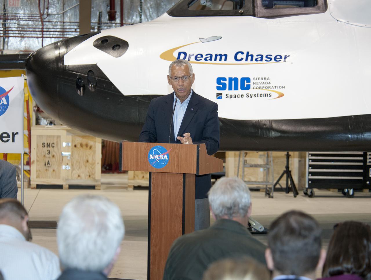 Edwards, Calif. – ED-0155-23 - NASA Administrator Charlie Bolden talks to the media about the importance of the agency's Commercial Crew Program, or CCP, and the development work Sierra Nevada Corporation, or SNC, will perform with its Dream Chaser flight test vehicle at the agency's Dryden Flight Research Center in the coming months.  SNC is one of three companies working with CCP during the agency's Commercial Crew Integrated Capability, or CCiCap, initiative, which is intended to lead to the availability of commercial human spaceflight services for government and commercial customers. To learn more about CCP and its industry partners, visit www.nasa.gov_commercialcrew.   Image credit: NASA_Ken Ulbrich