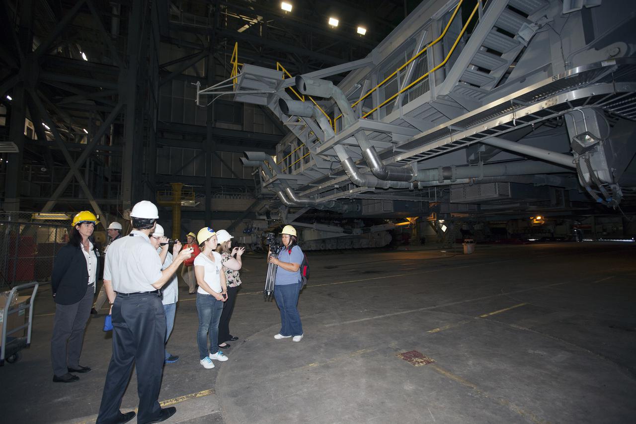--- CAPE CANAVERAL, Fla. – A group of nine Florida Institute of Technology aspiring journalists check out the mobile launcher inside the Vehicle Assembly Building, or VAB, at NASA's Kennedy Space Center in Florida on May 22. The group of students, in collaboration with Florida Today, is working on a multimedia project that examines health in zero gravity and how life in space can help people live better on Earth. These multimedia stories will be published for the print and online versions of Florida Today. During their visit, the students interviewed astronaut and Expedition 35 flight engineer Chris Cassidy during an International Space Station downlink in the Press Site auditorium. The journalists also met with Kennedy Director Bob Cabana who talked about NASA's goals for the future and his own experience in space, answering questions about health effects of spaceflight. The journalists also toured the Apollo Saturn V Center. Learn about the Florida Institute of Technology journalists' findings on their Facebook page at http:__www.facebook.com_FT3atFIT or Twitter at #SpaceHealth. Photo credit: Photo credit: NASA_Kim Shiflett