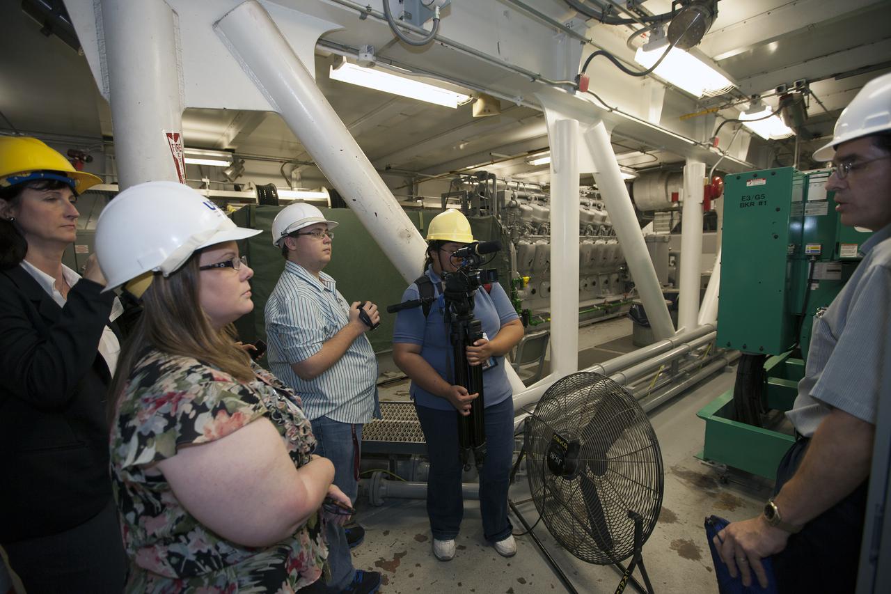 CAPE CANAVERAL, Fla. – A group of nine Florida Institute of Technology aspiring journalists observe the interior of the mobile launcher inside the Vehicle Assembly Building, or VAB, at NASA's Kennedy Space Center in Florida on May 22. The group of students, in collaboration with Florida Today, is working on a multimedia project that examines health in zero gravity and how life in space can help people live better on Earth. These multimedia stories will be published for the print and online versions of Florida Today. During their visit, the students interviewed astronaut and Expedition 35 flight engineer Chris Cassidy during an International Space Station downlink in the Press Site auditorium. The journalists also met with Kennedy Director Bob Cabana who talked about NASA's goals for the future and his own experience in space, answering questions about health effects of spaceflight. The journalists also toured the Apollo Saturn V Center. Learn about the Florida Institute of Technology journalists' findings on their Facebook page at http:__www.facebook.com_FT3atFIT or Twitter at #SpaceHealth. Photo credit: Photo credit: NASA_Kim Shiflett