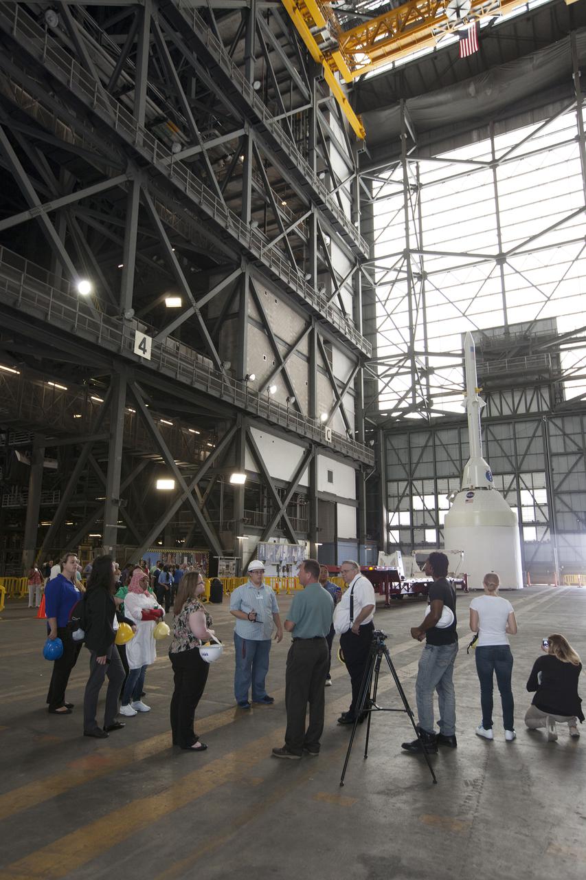 CAPE CANAVERAL, Fla. – A group of nine Florida Institute of Technology aspiring journalists congregate inside the Vehicle Assembly Building, or VAB, at NASA's Kennedy Space Center in Florida on May 22. The group of students, in collaboration with Florida Today, is working on a multimedia project that examines health in zero gravity and how life in space can help people live better on Earth. These multimedia stories will be published for the print and online versions of Florida Today. During their visit, the students interviewed astronaut and Expedition 35 flight engineer Chris Cassidy during an International Space Station downlink in the Press Site auditorium. The journalists also met with Kennedy Director Bob Cabana who talked about NASA's goals for the future and his own experience in space, answering questions about health effects of spaceflight. The journalists also toured the Apollo Saturn V Center. Learn about the Florida Institute of Technology journalists' findings on their Facebook page at http:__www.facebook.com_FT3atFIT or Twitter at #SpaceHealth. Photo credit: Photo credit: NASA_Kim Shiflett