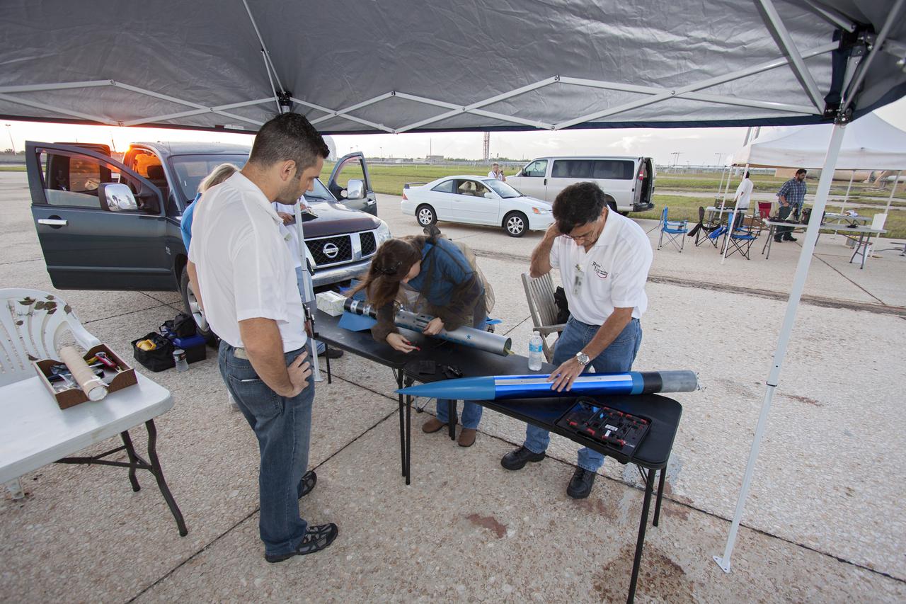 CAPE CANAVERAL, Fla. -- At NASA's Kennedy Space Center in Florida, engineers make final adjustments to a small rocket prior to launch as part of Rocket University. The goal was to test its systems and to verify that it performed as designed. As part of Rocket University, the engineers are given an opportunity to work a fast-track project to develop skills in developing spacecraft systems of the future. As NASA plans for future spaceflight programs to low-Earth orbit and beyond, teams of engineers at Kennedy are gaining experience in designing and flying launch vehicle systems on a small scale. Four teams of five to eight members from Kennedy are designing rockets complete with avionics and recovery systems. Launch operations require coordination with federal agencies, just as they would with rockets launched in support of a NASA mission. Photo credit: NASA_Jim Grossmann