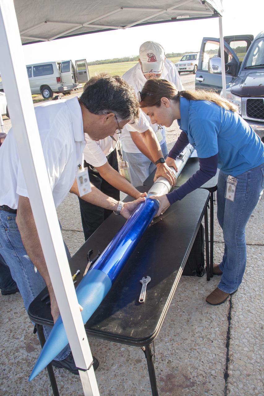 CAPE CANAVERAL, Fla. -- At NASA's Kennedy Space Center in Florida, engineers make final adjustments to a small rocket prior to launch as part of Rocket University. The goal was to test its systems and to verify that it performed as designed. As part of Rocket University, the engineers are given an opportunity to work a fast-track project to develop skills in developing spacecraft systems of the future. As NASA plans for future spaceflight programs to low-Earth orbit and beyond, teams of engineers at Kennedy are gaining experience in designing and flying launch vehicle systems on a small scale. Four teams of five to eight members from Kennedy are designing rockets complete with avionics and recovery systems. Launch operations require coordination with federal agencies, just as they would with rockets launched in support of a NASA mission. Photo credit: NASA_Jim Grossmann