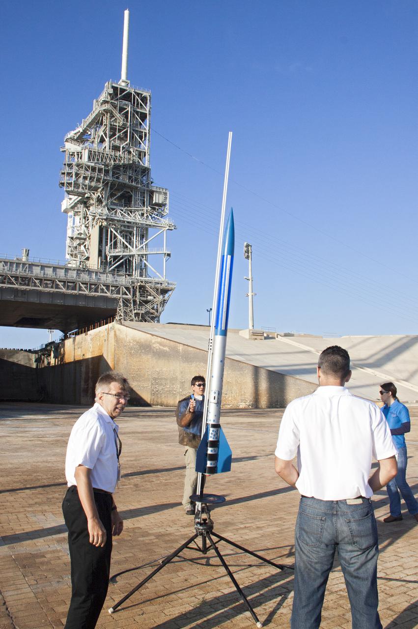 CAPE CANAVERAL, Fla. -- At NASA's Kennedy Space Center in Florida, engineers complete final checkouts of a small rocket on its launch stand as part of Rocket University. The goal was to test its systems and to verify that it performed as designed. As part of Rocket University, the engineers are given an opportunity to work a fast-track project to develop skills in developing spacecraft systems of the future. As NASA plans for future spaceflight programs to low-Earth orbit and beyond, teams of engineers at Kennedy are gaining experience in designing and flying launch vehicle systems on a small scale. Four teams of five to eight members from Kennedy are designing rockets complete with avionics and recovery systems. Launch operations require coordination with federal agencies, just as they would with rockets launched in support of a NASA mission. Photo credit: NASA_Jim Grossmann