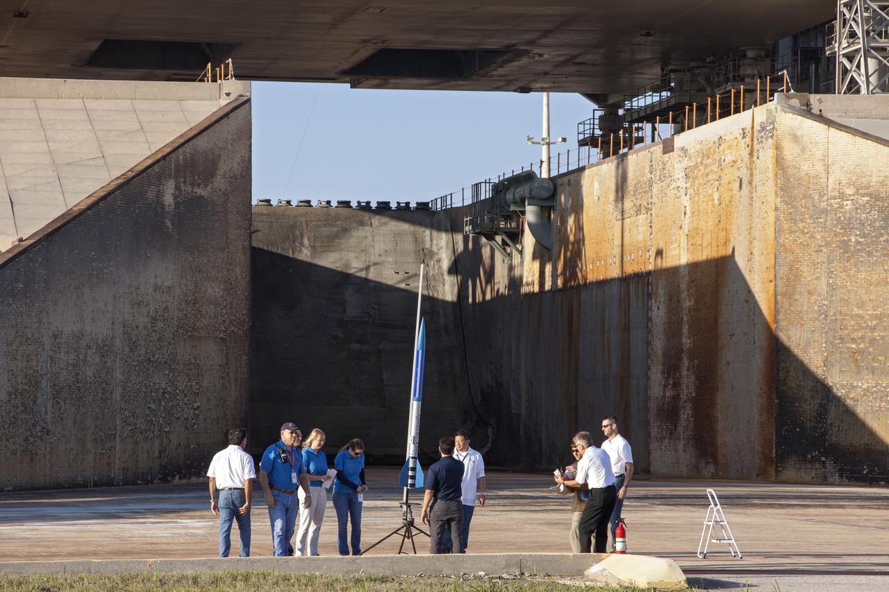 CAPE CANAVERAL, Fla. -- At NASA's Kennedy Space Center in Florida, engineers complete final checkouts of a small rocket on its launch stand as part of Rocket University. The goal was to test its systems and to verify that it performed as designed. As part of Rocket University, the engineers are given an opportunity to work a fast-track project to develop skills in developing spacecraft systems of the future. As NASA plans for future spaceflight programs to low-Earth orbit and beyond, teams of engineers at Kennedy are gaining experience in designing and flying launch vehicle systems on a small scale. Four teams of five to eight members from Kennedy are designing rockets complete with avionics and recovery systems. Launch operations require coordination with federal agencies, just as they would with rockets launched in support of a NASA mission. Photo credit: NASA_Jim Grossmann