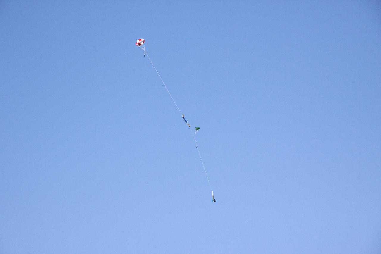 CAPE CANAVERAL, Fla. -- At NASA's Kennedy Space Center in Florida, a small rocket descends under a parachute after liftoff from Launch Pad 39A as part of Rocket University. The goal was to test its systems and to verify that it performed as designed. As part of Rocket University, the engineers are given an opportunity to work a fast-track project to develop skills in developing spacecraft systems of the future. As NASA plans for future spaceflight programs to low-Earth orbit and beyond, teams of engineers at Kennedy are gaining experience in designing and flying launch vehicle systems on a small scale. Four teams of five to eight members from Kennedy are designing rockets complete with avionics and recovery systems. Launch operations require coordination with federal agencies, just as they would with rockets launched in support of a NASA mission. Photo credit: NASA_Jim Grossmann