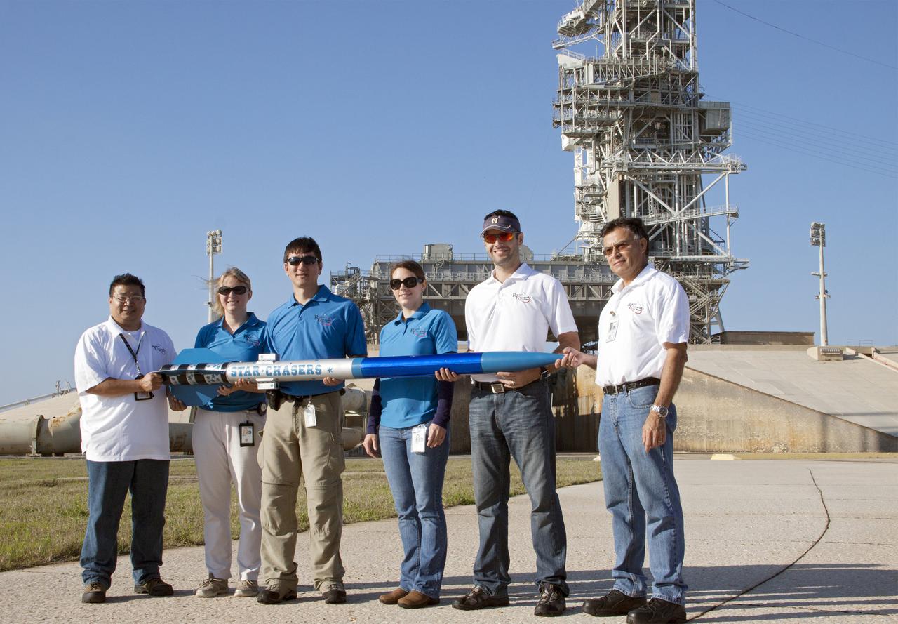 CAPE CANAVERAL, Fla. -- At NASA's Kennedy Space Center in Florida, engineers display a small rocket following its launch as part of Rocket University. From the left are Myphi Tran of Flight Instrumentation, Susan Danley of Flight Structures, Morgan Simpson of Flight Hardware Processing, Kim Simpson of Fluids, Mechanical and Structural Systems, Leandro James of Systems Hardware Engineering and Julio Najarro of Mechanical Assembly, Lifting and Handling. The goal was to test its systems and to verify that it performed as designed. As part of Rocket University, the engineers are given an opportunity to work a fast-track project to develop skills in developing spacecraft systems of the future. As NASA plans for future spaceflight programs to low-Earth orbit and beyond, teams of engineers at Kennedy are gaining experience in designing and flying launch vehicle systems on a small scale. Four teams of five to eight members from Kennedy are designing rockets complete with avionics and recovery systems. Launch operations require coordination with federal agencies, just as they would with rockets launched in support of a NASA mission. Photo credit: NASA_Jim Grossmann