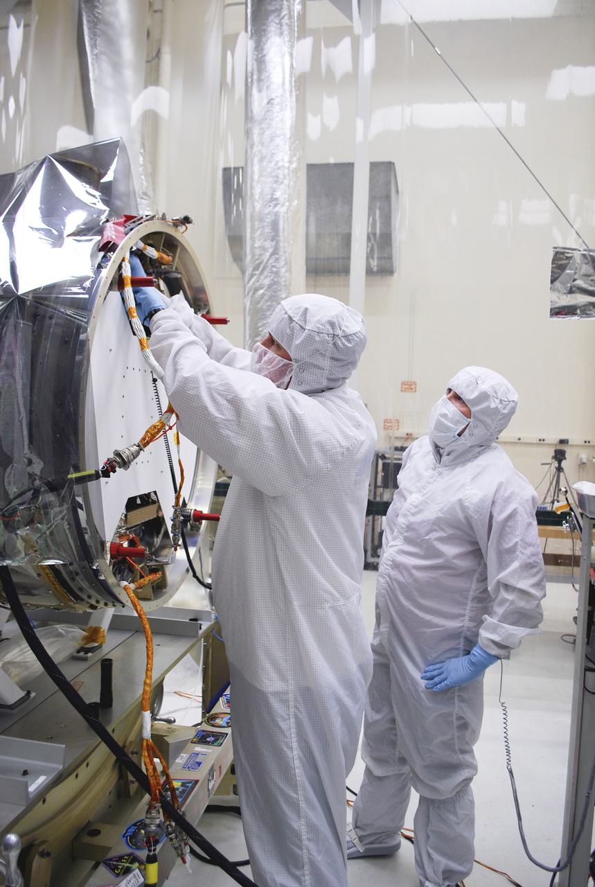 VANDENBERG, AFB - Engineers and members of the IRIS-Pegasus launch team re-verify the spacecraft ahead of the next flight simulation for the mission. The work is taking place in a hangar at Vandenberg where NASA's IRIS spacecraft, short for Interface Region Imaging Spectrograph, is being prepared for launch on a Pegasus XL rocket. Scheduled for launch from Vandenberg Air Force Base no earlier than June 26, 2013, IRIS will open a new window of discovery by tracing the flow of energy and plasma through the chromospheres and transition region into the sun’s corona using spectrometry and imaging. IRIS fills a crucial gap in our ability to advance studies of the sun-to-Earth connection by tracing the flow of energy and plasma through the foundation of the corona and the region around the sun known as the heliosphere. Photo credit: NASA_Randy Beaudoin