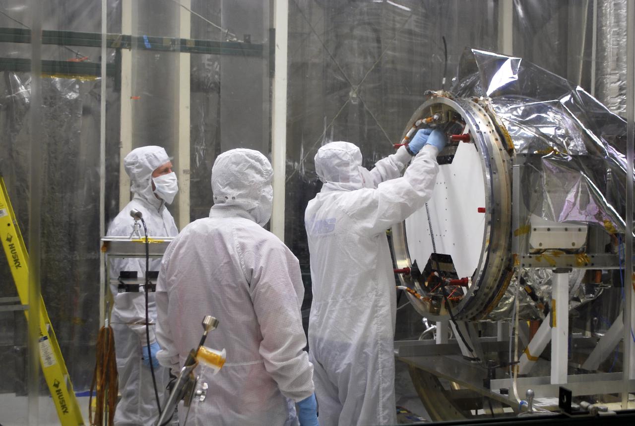 VANDENBERG, AFB - Engineers and members of the IRIS-Pegasus launch team re-verify the spacecraft ahead of the next flight simulation for the mission. The work is taking place in a hangar at Vandenberg where NASA's IRIS spacecraft, short for Interface Region Imaging Spectrograph, is being prepared for launch on a Pegasus XL rocket. Scheduled for launch from Vandenberg Air Force Base no earlier than June 26, 2013, IRIS will open a new window of discovery by tracing the flow of energy and plasma through the chromospheres and transition region into the sun’s corona using spectrometry and imaging. IRIS fills a crucial gap in our ability to advance studies of the sun-to-Earth connection by tracing the flow of energy and plasma through the foundation of the corona and the region around the sun known as the heliosphere. Photo credit: NASA_Randy Beaudoin