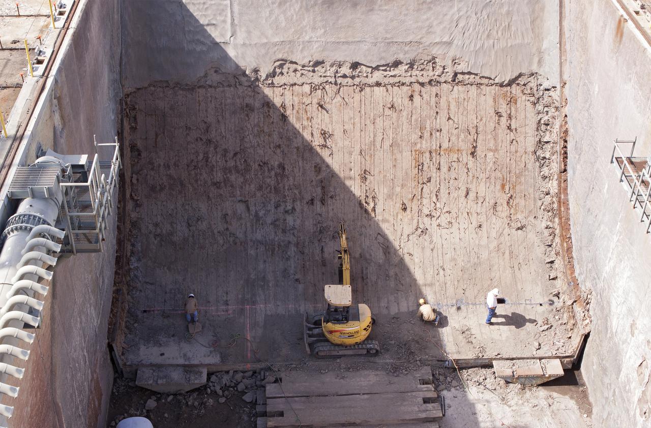 CAPE CANAVERAL, Fla. -- At Launch Pad 39B at NASA’s Kennedy Space Center in Florida, workers are removing the flame trench deflector that sits below and between the left and right crawler track panels.    Launch Pad 39B is being refurbished to support NASA’s Space Launch System and other launch vehicles. The Ground Systems Development and Operations, or GSDO, Program office at Kennedy is leading the center’s transformation to safely handle a variety of rockets and spacecraft. For more information about GSDO, visit: http:__go.nasa.gov_groundsystems.  Photo credit: NASA_Jim Grossman