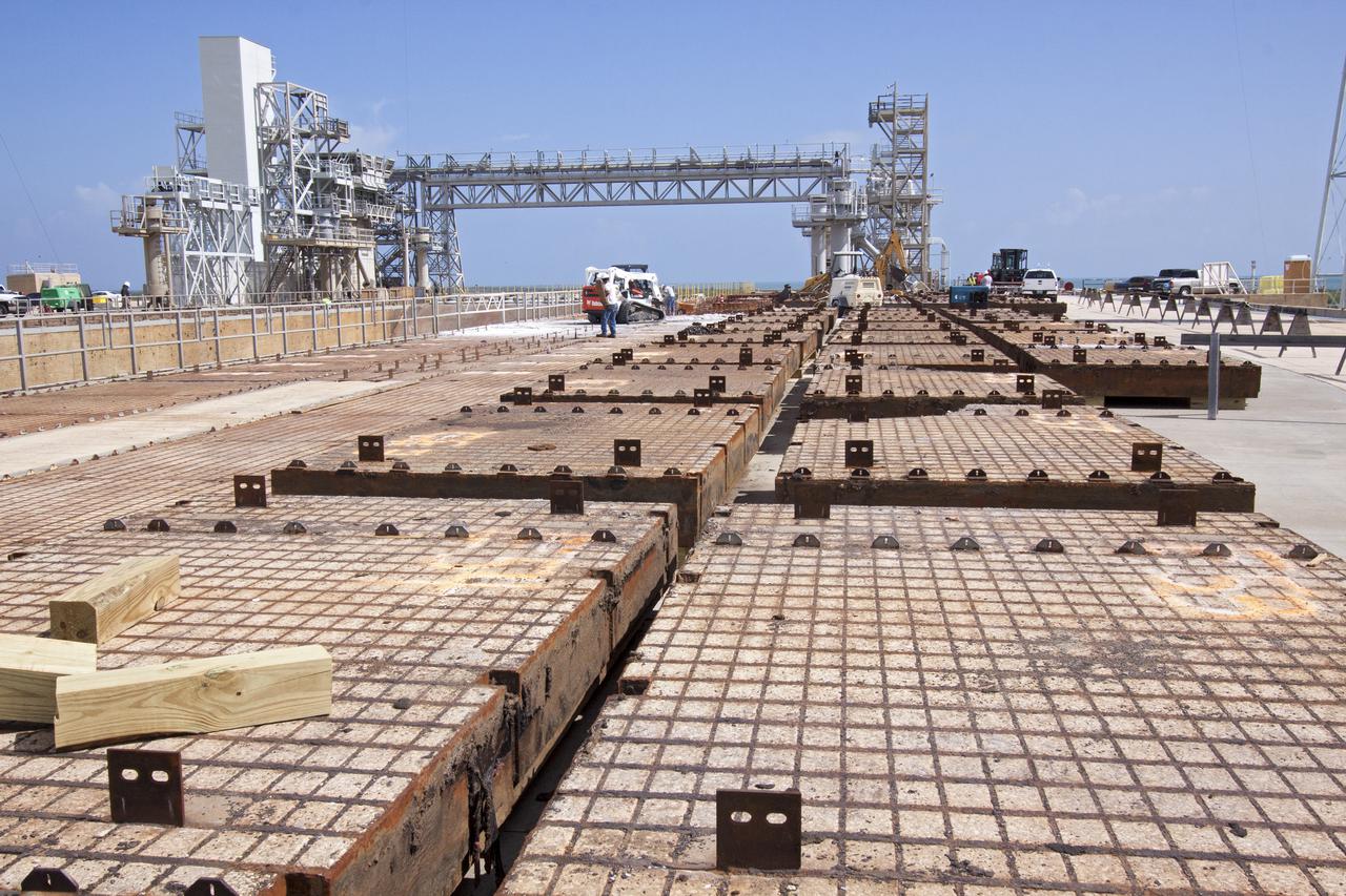 CAPE CANAVERAL, Fla. -- At Launch Pad 39B at NASA’s Kennedy Space Center in Florida, removal of the crawler track panels on the pad’s surface is underway. The concrete surface beneath the panels and the catacomb roof below will be inspected for water damage and repaired.    There are 176 panels, each weighing about 30,000 pounds that will be removed. Launch Pad 39B is being refurbished to support NASA’s Space Launch System and other launch vehicles. The Ground Systems Development and Operations, or GSDO, Program office at Kennedy is leading the center’s transformation to safely handle a variety of rockets and spacecraft. For more information about GSDO, visit: http:__go.nasa.gov_groundsystems.  Photo credit: NASA_Jim Grossman