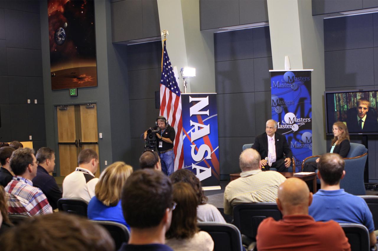 CAPE CANAVERAL, Fla. – At NASA's Kennedy Space Center in Florida, Ed Hoffman and Annie Caraccio discuss the 'Young Professional's Perspective at NASA' during the final day of a weeklong series called 'Masters with Masters.' Hoffman, NASA's chief Knowledge officer, and Caraccio, a chemical engineer in the Engineering and Technology Directorate at Kennedy, were joined by Philip Harris, an International Operations engineer from the Johnson Space Center via a television link with NASA's office in Moscow. Photo credit: NASA_Jim Grossmann