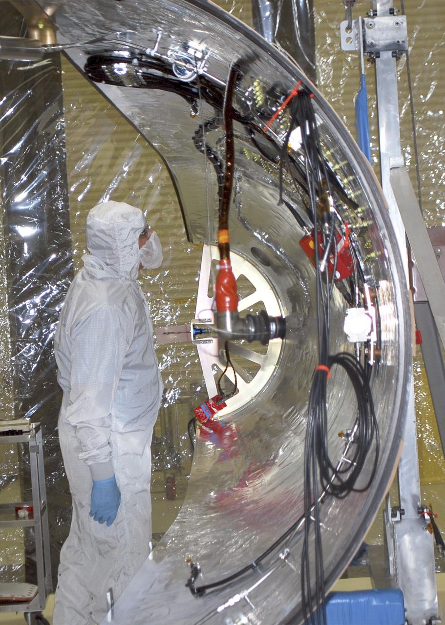 VANDENBERG AFB – An engineer examines the payload fairing into place for NASA's IRIS spacecraft. The fairing connects to the nose of the Orbital Sciences Pegasus XL rocket that will lift the solar observatory into orbit in June. The work is taking place in a hangar at Vandenberg Air Force Base where IRIS, short for Interface Region Imaging Spectrograph, is being prepared for launch on a Pegasus XL rocket. Scheduled for launch from Vandenberg June 26, IRIS will open a new window of discovery by tracing the flow of energy and plasma through the chromospheres and transition region into the sun’s corona using spectrometry and imaging. IRIS fills a crucial gap in our ability to advance studies of the sun-to-Earth connection by tracing the flow of energy and plasma through the foundation of the corona and the region around the sun known as the heliosphere. Photo credit: NASA_Randy Beaudoin