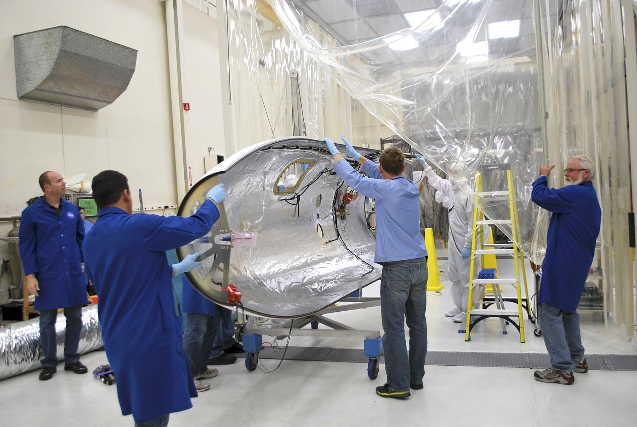 VANDENBERG AFB – Engineers move the payload fairing into place for NASA's IRIS spacecraft. The fairing connects to the nose of the Orbital Sciences Pegasus XL rocket that will lift the solar observatory into orbit in June. The work is taking place in a hangar at Vandenberg Air Force Base where IRIS, short for Interface Region Imaging Spectrograph, is being prepared for launch on a Pegasus XL rocket. Scheduled for launch from Vandenberg June 26, IRIS will open a new window of discovery by tracing the flow of energy and plasma through the chromospheres and transition region into the sun’s corona using spectrometry and imaging. IRIS fills a crucial gap in our ability to advance studies of the sun-to-Earth connection by tracing the flow of energy and plasma through the foundation of the corona and the region around the sun known as the heliosphere. Photo credit: NASA_Randy Beaudoin