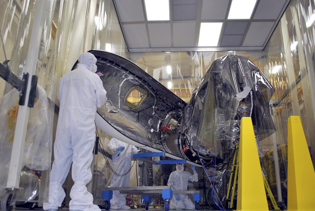 VANDENBERG AFB – Engineers move the payload fairing into place for NASA's IRIS spacecraft. The fairing connects to the nose of the Orbital Sciences Pegasus XL rocket that will lift the solar observatory into orbit in June. The work is taking place in a hangar at Vandenberg Air Force Base where IRIS, short for Interface Region Imaging Spectrograph, is being prepared for launch on a Pegasus XL rocket. Scheduled for launch from Vandenberg June 26, IRIS will open a new window of discovery by tracing the flow of energy and plasma through the chromospheres and transition region into the sun’s corona using spectrometry and imaging. IRIS fills a crucial gap in our ability to advance studies of the sun-to-Earth connection by tracing the flow of energy and plasma through the foundation of the corona and the region around the sun known as the heliosphere. Photo credit: NASA_Randy Beaudoin