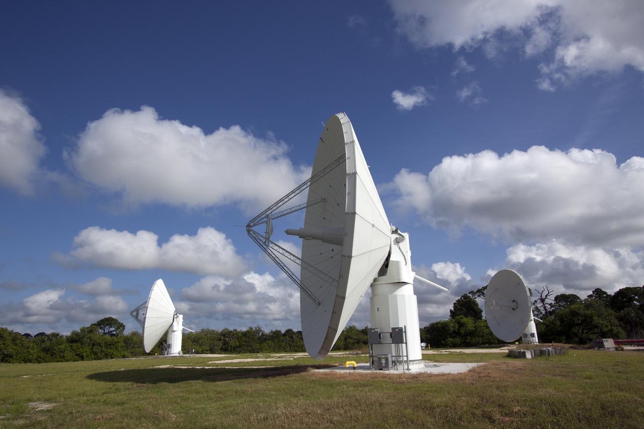 CAPE CANAVERAL, Fla. -- At NASA’s Kennedy Space Center in Florida, the three Ka-Band Objects Observation and Monitoring, or Ka-BOOM, testbed antennas are used to track the pattern of the sun during initial testing of the new system.  The goal of Ka-BOOM is to prove technologies that will allow future systems to characterize near-Earth objects in terms of size, shape, rotation_tumble rate and to determine the trajectory of those objects. Radar studies can determine the trajectory 100,000 times more precisely than can optical methods. While also capable of space communication and radio science experiments, developing radar applications is the primary focus of the arrays. The 40-foot-diameter dish antenna arrays are at the site of the former Vertical Processing Facility, which has been demolished. Photo credit: NASA_Jim Grossmann