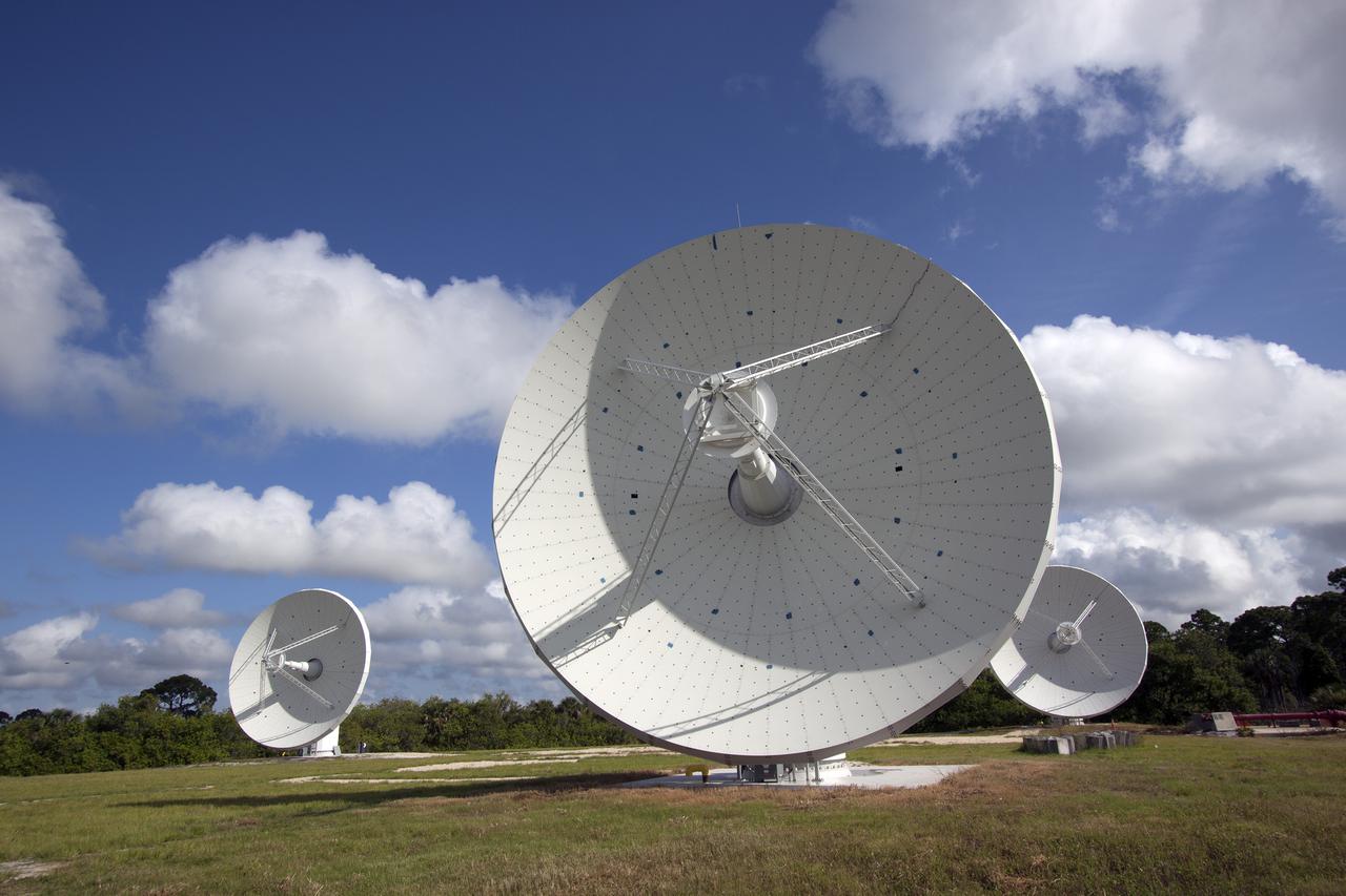 CAPE CANAVERAL, Fla. -- At NASA’s Kennedy Space Center in Florida, the three Ka-Band Objects Observation and Monitoring, or Ka-BOOM, testbed antennas are used to track the pattern of the sun during initial testing of the new system.  The goal of Ka-BOOM is to prove technologies that will allow future systems to characterize near-Earth objects in terms of size, shape, rotation_tumble rate and to determine the trajectory of those objects. Radar studies can determine the trajectory 100,000 times more precisely than can optical methods. While also capable of space communication and radio science experiments, developing radar applications is the primary focus of the arrays. The 40-foot-diameter dish antenna arrays are at the site of the former Vertical Processing Facility, which has been demolished. Photo credit: NASA_Jim Grossmann