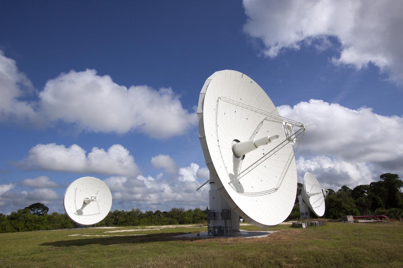 CAPE CANAVERAL, Fla. -- At NASA’s Kennedy Space Center in Florida, the three Ka-Band Objects Observation and Monitoring, or Ka-BOOM, testbed antennas are used to track the pattern of the sun during initial testing of the new system.  The goal of Ka-BOOM is to prove technologies that will allow future systems to characterize near-Earth objects in terms of size, shape, rotation_tumble rate and to determine the trajectory of those objects. Radar studies can determine the trajectory 100,000 times more precisely than can optical methods. While also capable of space communication and radio science experiments, developing radar applications is the primary focus of the arrays. The 40-foot-diameter dish antenna arrays are at the site of the former Vertical Processing Facility, which has been demolished. Photo credit: NASA_Jim Grossmann