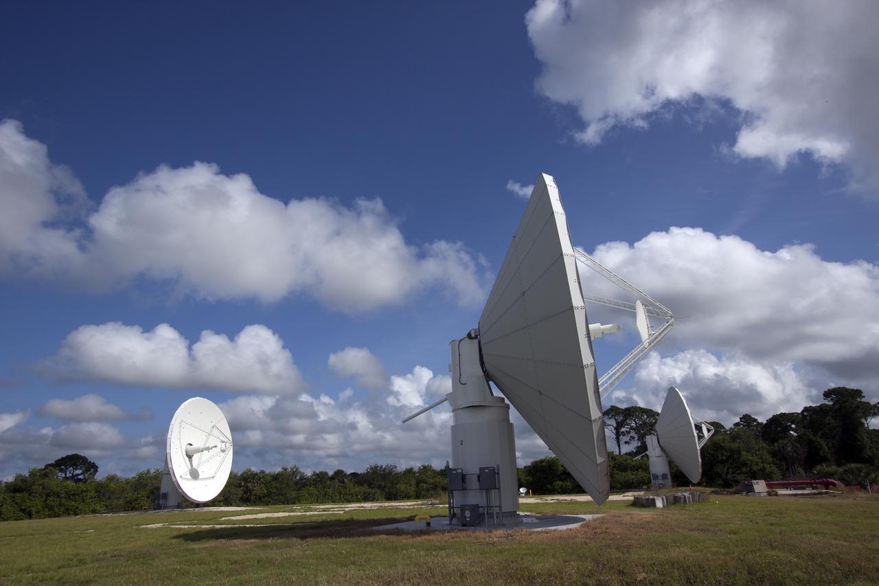 CAPE CANAVERAL, Fla. -- At NASA’s Kennedy Space Center in Florida, the three Ka-Band Objects Observation and Monitoring, or Ka-BOOM, testbed antennas are used to track the pattern of the sun during initial testing of the new system.  The goal of Ka-BOOM is to prove technologies that will allow future systems to characterize near-Earth objects in terms of size, shape, rotation_tumble rate and to determine the trajectory of those objects. Radar studies can determine the trajectory 100,000 times more precisely than can optical methods. While also capable of space communication and radio science experiments, developing radar applications is the primary focus of the arrays. The 40-foot-diameter dish antenna arrays are at the site of the former Vertical Processing Facility, which has been demolished. Photo credit: NASA_Jim Grossmann