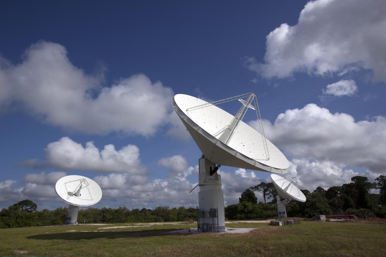 CAPE CANAVERAL, Fla. -- At NASA’s Kennedy Space Center in Florida, the three Ka-Band Objects Observation and Monitoring, or Ka-BOOM, testbed antennas are used to track the pattern of the sun during initial testing of the new system.  The goal of Ka-BOOM is to prove technologies that will allow future systems to characterize near-Earth objects in terms of size, shape, rotation_tumble rate and to determine the trajectory of those objects. Radar studies can determine the trajectory 100,000 times more precisely than can optical methods. While also capable of space communication and radio science experiments, developing radar applications is the primary focus of the arrays. The 40-foot-diameter dish antenna arrays are at the site of the former Vertical Processing Facility, which has been demolished. Photo credit: NASA_Jim Grossmann