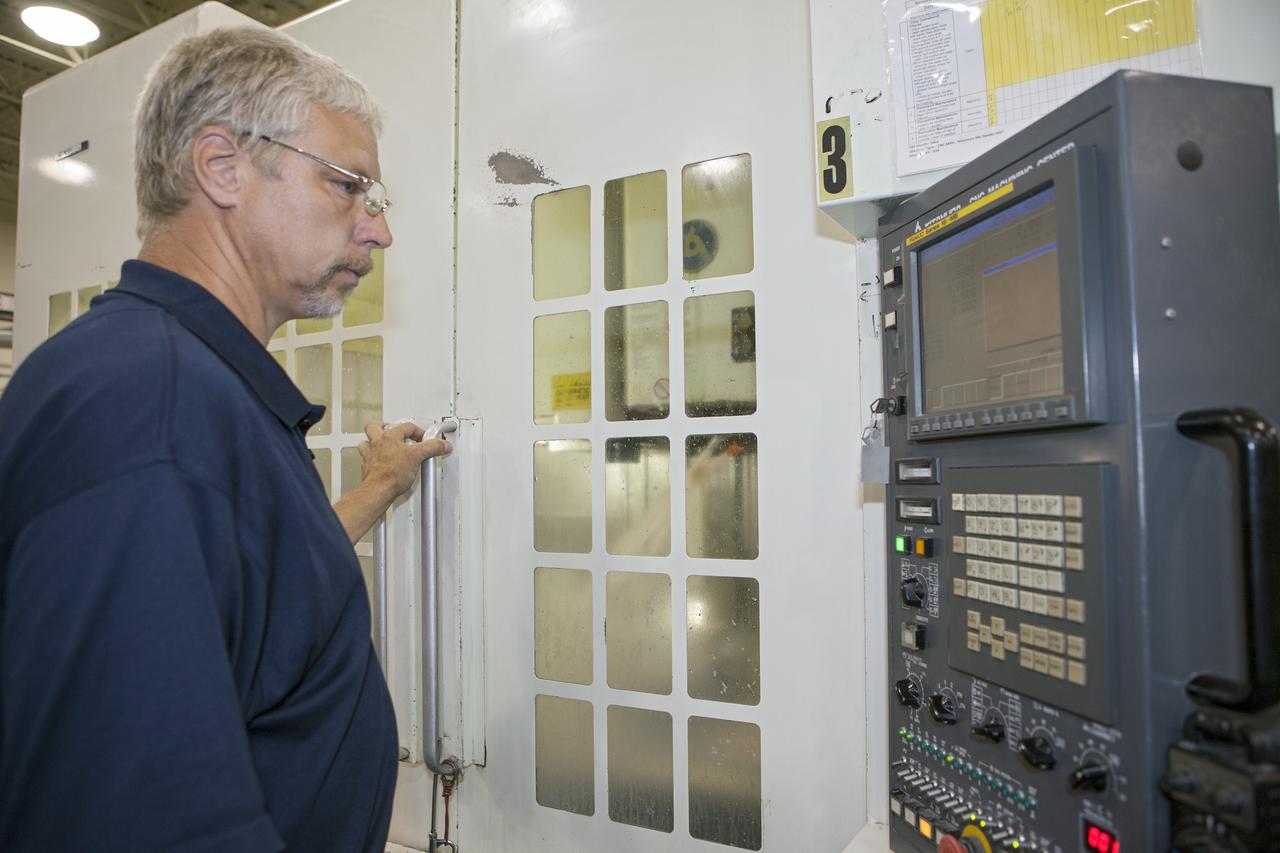 CAPE CANAVERAL, Fla. – At the Aerospace and Defense Manufacturing Center in Cape Canaveral, Fla., Craig Technologies Mechanical Engineer Technician Mike Cousineau checks the performance of one of the 1,600 pieces of specialty equipment at the 161,000-square-foot facility.   In June of last year, NASA signed a partnership agreement with Craig Technologies to maintain an inventory of unique processing and manufacturing equipment for future mission support at the agency's Kennedy Space Center. The Cape Canaveral, Fla., facility, formerly known as the NASA Shuttle Logistics Depot NSLD, is now the Aerospace and Defense Manufacturing Center ADMC. Photo credit: NASA_Kim Shiflett
