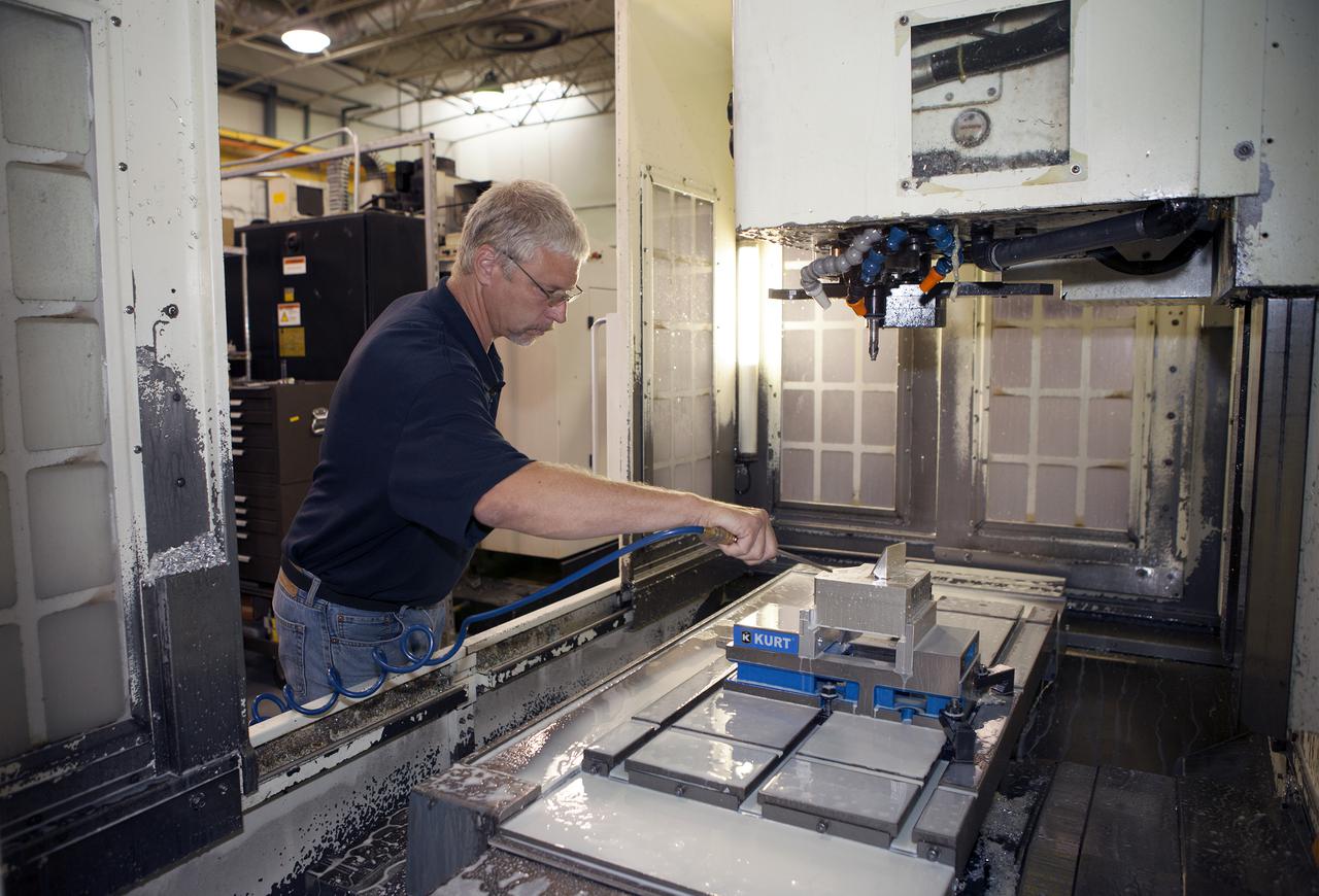 CAPE CANAVERAL, Fla. – At the Aerospace and Defense Manufacturing Center in Cape Canaveral, Fla., Craig Technologies Mechanical Engineer Technician Mike Cousineau checks the performance of one of the 1,600 pieces of specialty equipment at the 161,000-square-foot facility.   In June of last year, NASA signed a partnership agreement with Craig Technologies to maintain an inventory of unique processing and manufacturing equipment for future mission support at the agency's Kennedy Space Center. The Cape Canaveral, Fla., facility, formerly known as the NASA Shuttle Logistics Depot NSLD, is now the Aerospace and Defense Manufacturing Center ADMC. Photo credit: NASA_Kim Shiflett