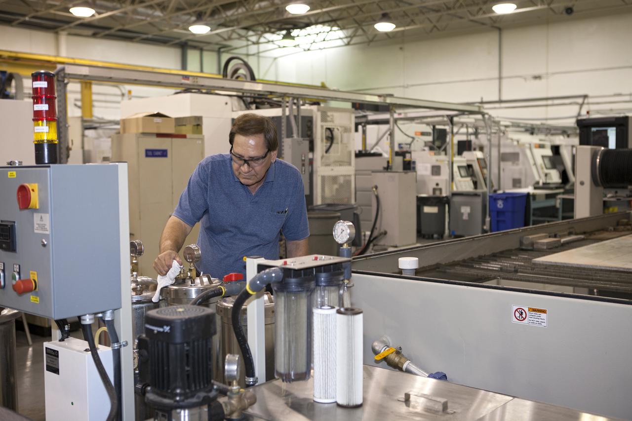 CAPE CANAVERAL, Fla. – At the Aerospace and Defense Manufacturing Center in Cape Canaveral, Fla., Jim England of Craig Technologies Environmental, Health and Safety checks the performance of one of the 1,600 pieces of specialty equipment at the 161,000-square-foot facility.   In June of last year, NASA signed a partnership agreement with Craig Technologies to maintain an inventory of unique processing and manufacturing equipment for future mission support at the agency's Kennedy Space Center. The Cape Canaveral, Fla., facility, formerly known as the NASA Shuttle Logistics Depot NSLD, is now the Aerospace and Defense Manufacturing Center ADMC. Photo credit: NASA_Kim Shiflett