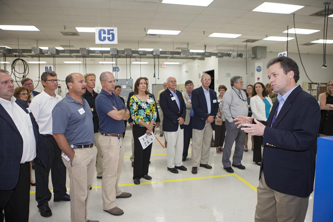 CAPE CANAVERAL, Fla. – At the Aerospace and Defense Manufacturing Center in Cape Canaveral, Fla., Craig Technologies Vice President and Site Director Jim Kell describes operations at the 161,000-square-foot facility during a community open house.   In June of last year, NASA signed a partnership agreement with Craig Technologies to maintain an inventory of unique processing and manufacturing equipment for future mission support at the agency's Kennedy Space Center. The Cape Canaveral, Fla., facility, formerly known as the NASA Shuttle Logistics Depot NSLD, is now the Aerospace and Defense Manufacturing Center ADMC. Photo credit: NASA_Kim Shiflett