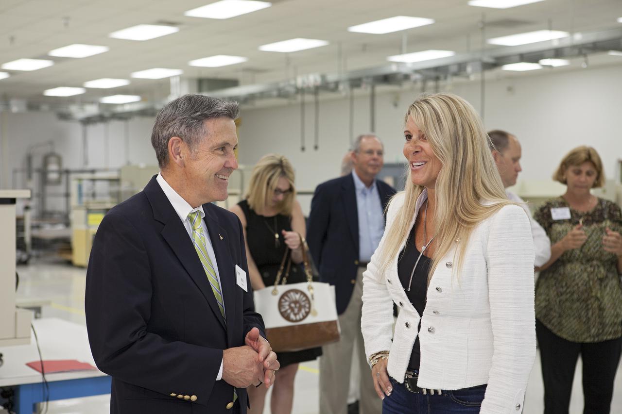 CAPE CANAVERAL, Fla. – At the Aerospace and Defense Manufacturing Center in Cape Canaveral, Fla., Kennedy Space Center Director Bob Cabana talks with Craig Technologies founder and chief executive officer Carol Craig during a community open house.   In June of last year, NASA signed a partnership agreement with Craig Technologies to maintain an inventory of unique processing and manufacturing equipment for future mission support at the agency's Kennedy Space Center. The Cape Canaveral, Fla., facility, formerly known as the NASA Shuttle Logistics Depot NSLD, is now the Aerospace and Defense Manufacturing Center ADMC. Photo credit: NASA_Kim Shiflett