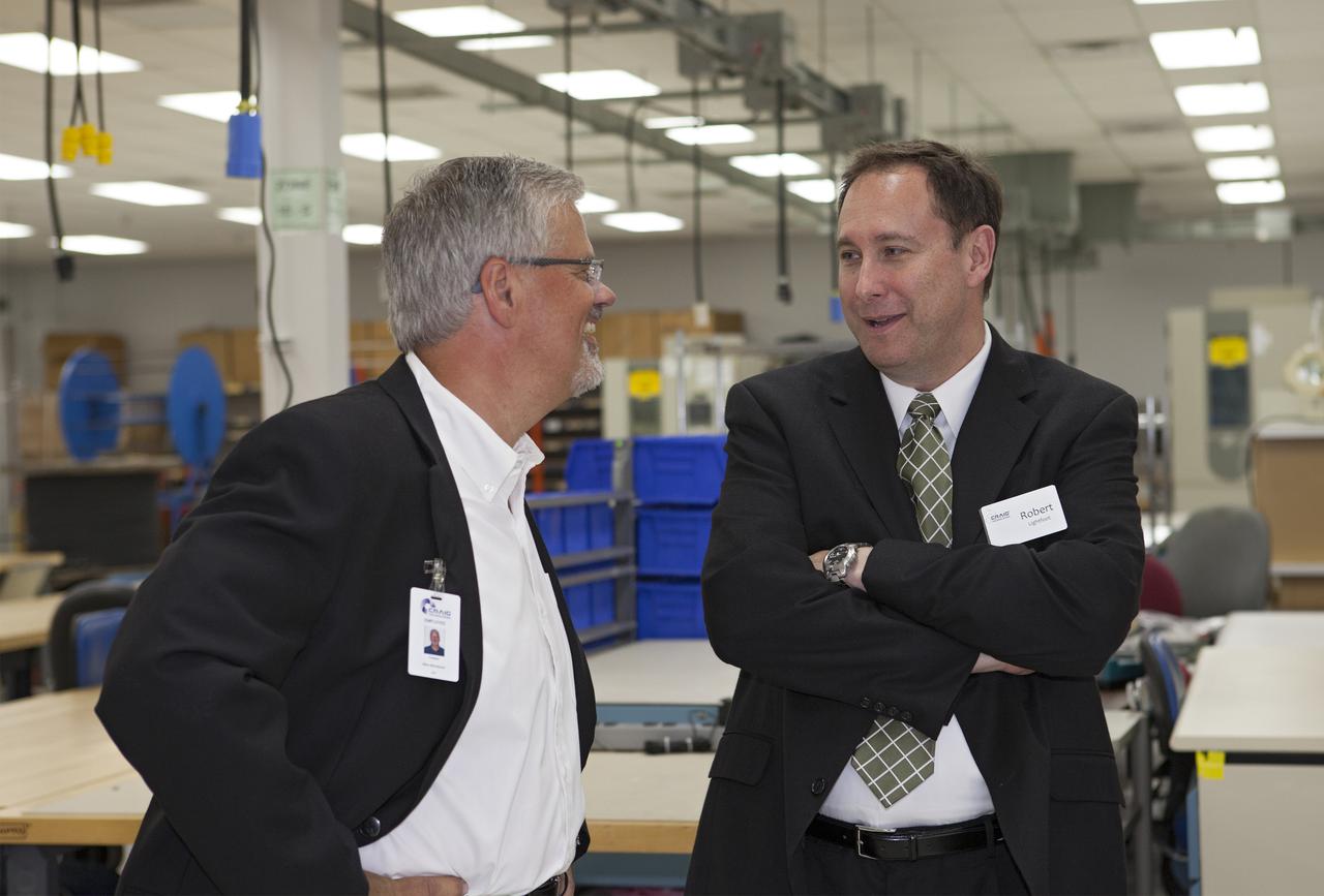 CAPE CANAVERAL, Fla. – At the Aerospace and Defense Manufacturing Center in Cape Canaveral, Fla., Craig Technologies President Mark Mikolajczyk talks with NASA Associate Administrator Robert Lightfoot during a community open house.   In June of last year, NASA signed a partnership agreement with Craig Technologies to maintain an inventory of unique processing and manufacturing equipment for future mission support at the agency's Kennedy Space Center. The Cape Canaveral, Fla., facility, formerly known as the NASA Shuttle Logistics Depot NSLD, is now the Aerospace and Defense Manufacturing Center ADMC. Photo credit: NASA_Kim Shiflett