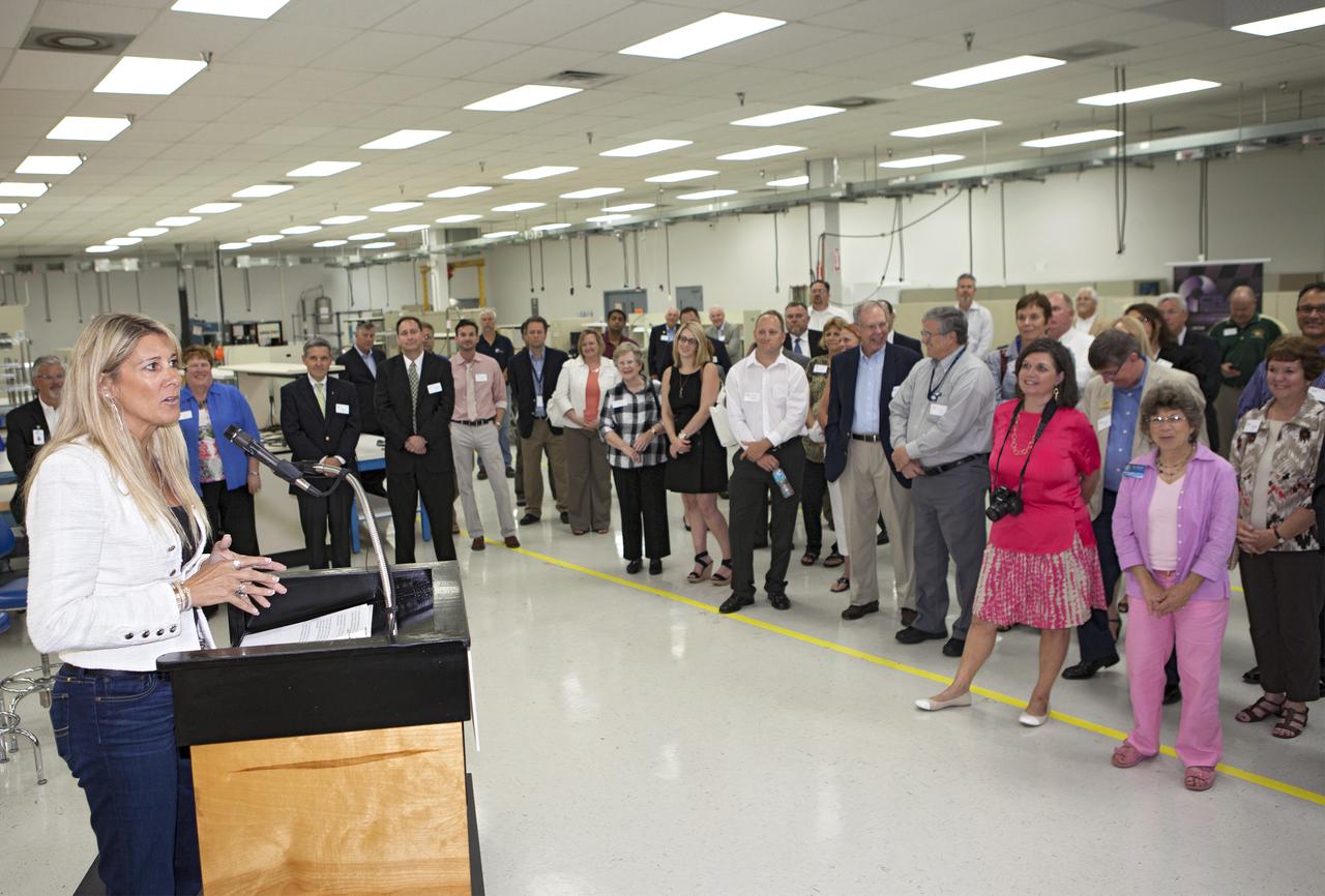 CAPE CANAVERAL, Fla. – At the Aerospace and Defense Manufacturing Center in Cape Canaveral, Fla., Craig Technologies founder and chief executive officer Carol Craig speaks to guests during a community open house at the 161,000-square-foot facility.   In June of last year, NASA signed a partnership agreement with Craig Technologies to maintain an inventory of unique processing and manufacturing equipment for future mission support at the agency's Kennedy Space Center. The Cape Canaveral, Fla., facility, formerly known as the NASA Shuttle Logistics Depot NSLD, is now the Aerospace and Defense Manufacturing Center ADMC. Photo credit: NASA_Kim Shiflett