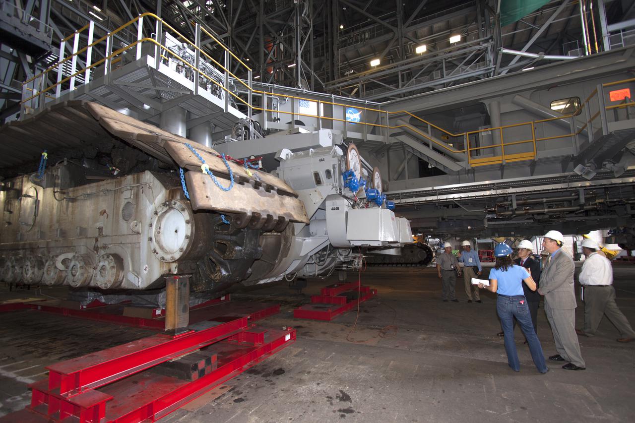 CAPE CANAVERAL, Fla. – NASA Associate Administrator Robert Lightfoot, second from right, is briefed on the modifications to crawler-transporter 2 in the Vehicle Assembly Building, or VAB, during a visit to NASA's Kennedy Space Center in Florida.  From left are Mary Hanna, crawler-transporter project manager, Kennedy Director Bob Cabana, Lightfoot, and Shawn Quinn, Vehicle Integration and Launch Integration Product Team, or IPT, manager. Crawler-transporter 2 is being readied to support NASA's new Orion spacecraft and Space Launch System heavy-lift rocket, the SLS.  NASA's FY2014 budget proposal includes a plan to robotically capture a small near-Earth asteroid and redirect it safely to a stable orbit in the Earth-moon system where astronauts can visit and explore it. Performing these elements for the proposed asteroid initiative integrates the best of NASA's science, technology and human exploration capabilities and draws on the innovation of America's brightest scientists and engineers. It uses current and developing capabilities to find both large asteroids that pose a hazard to Earth and small asteroids that could be candidates for the initiative, accelerates our technology development activities in high-powered solar electric propulsion and takes advantage of our hard work on the Space Launch System rocket and Orion spacecraft, helping to keep NASA on target to reach the President's goal of sending humans to Mars in the 2030s. Photo credit: NASA_Jim Grossmann
