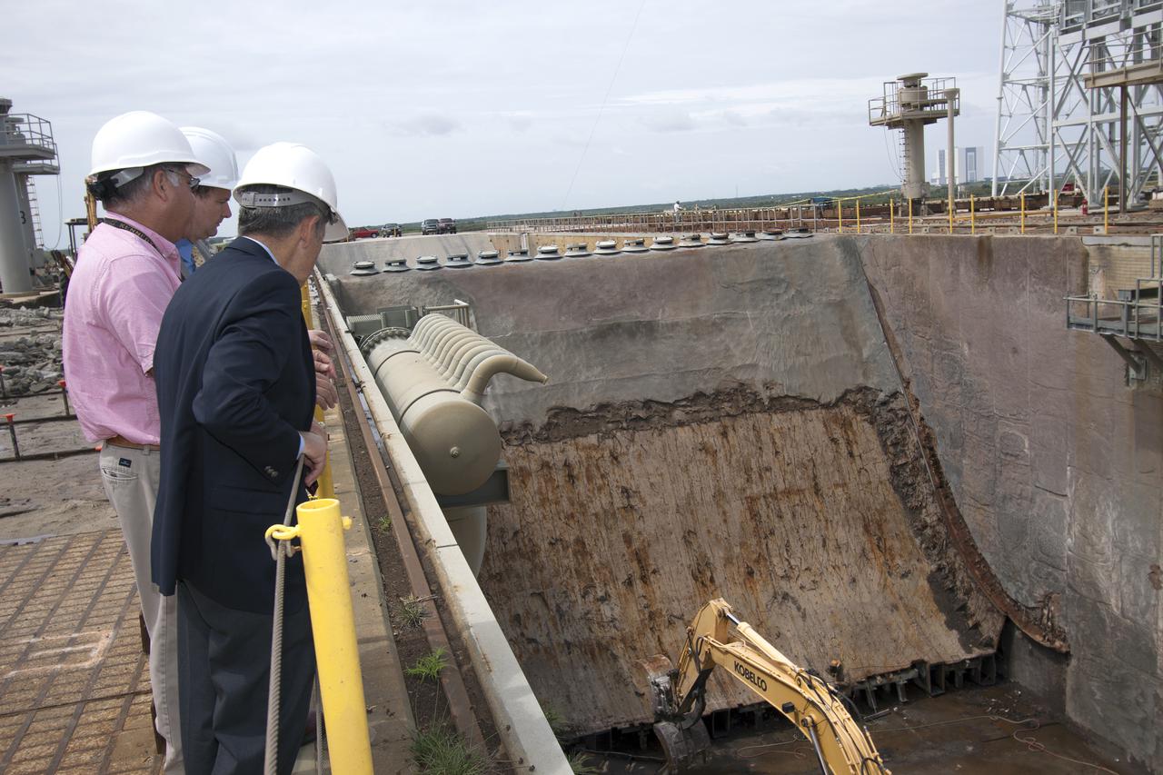 CAPE CANAVERAL, Fla. – NASA Associate Administrator Robert Lightfoot gets a close look at the flame deflector on Launch Pad 39B during a visit to NASA's Kennedy Space Center in Florida. From left are Lightfoot, Jose Perez Morales, launch pad project manager, and Kennedy Director Bob Cabana.  The pad is being modified to support NASA's new Orion spacecraft and Space Launch System heavy-lift rocket, the SLS.  NASA's FY2014 budget proposal includes a plan to robotically capture a small near-Earth asteroid and redirect it safely to a stable orbit in the Earth-moon system where astronauts can visit and explore it. Performing these elements for the proposed asteroid initiative integrates the best of NASA's science, technology and human exploration capabilities and draws on the innovation of America's brightest scientists and engineers. It uses current and developing capabilities to find both large asteroids that pose a hazard to Earth and small asteroids that could be candidates for the initiative, accelerates our technology development activities in high-powered solar electric propulsion and takes advantage of our hard work on the Space Launch System rocket and Orion spacecraft, helping to keep NASA on target to reach the President's goal of sending humans to Mars in the 2030s. Photo credit: NASA_Jim Grossmann