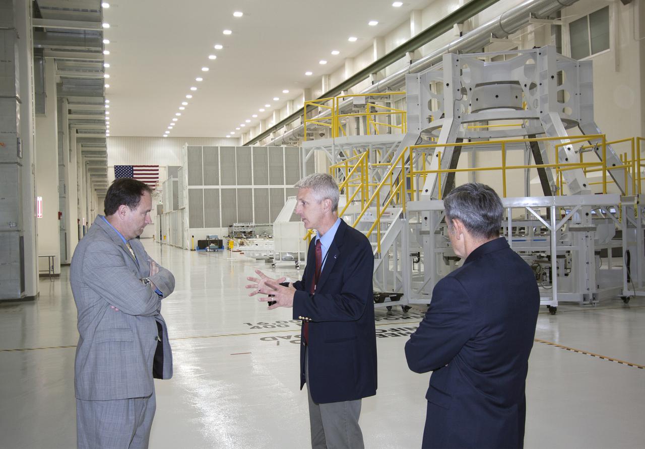 CAPE CANAVERAL, Fla. – During a visit to NASA's Kennedy Space Center in Florida, NASA Associate Administrator Robert Lightfoot tours the Operations and Checkout Building high bay where the first Orion capsule, NASA's multi-purpose crew vehicle, is being prepared for flight on Exploration Flight Test 1, or EFT-1, in 2014. From left are Lightfoot, Kennedy's manager of Orion Production Operations Scott Wilson, and Kennedy Director Bob Cabana. Orion is NASA's next-generation transport for astronauts to destinations beyond Earth orbit. NASA's FY2014 budget proposal includes a plan to robotically capture a small near-Earth asteroid and redirect it safely to a stable orbit in the Earth-moon system where astronauts can visit and explore it. Performing these elements for the proposed asteroid initiative integrates the best of NASA's science, technology and human exploration capabilities and draws on the innovation of America's brightest scientists and engineers. It uses current and developing capabilities to find both large asteroids that pose a hazard to Earth and small asteroids that could be candidates for the initiative, accelerates our technology development activities in high-powered solar electric propulsion and takes advantage of our hard work on the Space Launch System rocket and Orion spacecraft, helping to keep NASA on target to reach the President's goal of sending humans to Mars in the 2030s. Photo credit: NASA_Jim Grossmann