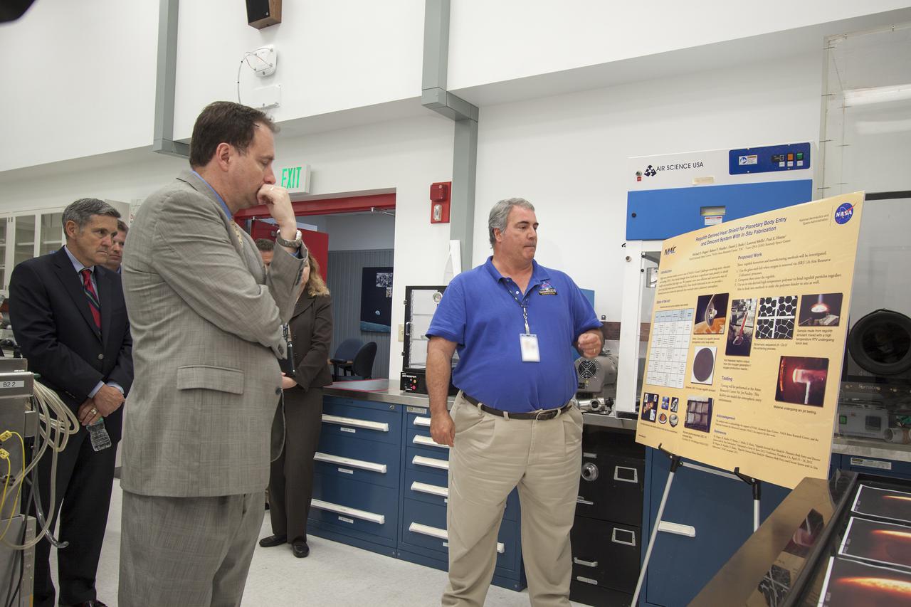 CAPE CANAVERAL, Fla. – At NASA’s Kennedy Space Center in Florida, Robert Lightfoot, NASA associate director, second from left, learns about surface systems technologies for destinations beyond Earth during a tour of the Swamp Works laboratories. At far left is Kennedy Director Bob Cabana. Kennedy’s Swamp Works provides rapid, innovative and cost-effective exploration mission solutions, leveraging partnerships across NASA, industry and academia. Kennedy’s research and technology mission is to improve spaceports on Earth, as well as lay the groundwork for establishing spaceports at destinations in space. For more information, visit http:__www.nasa.gov_centers_kennedy_exploration_researchtech_index.html. Photo credit: NASA_Jim Grossmann