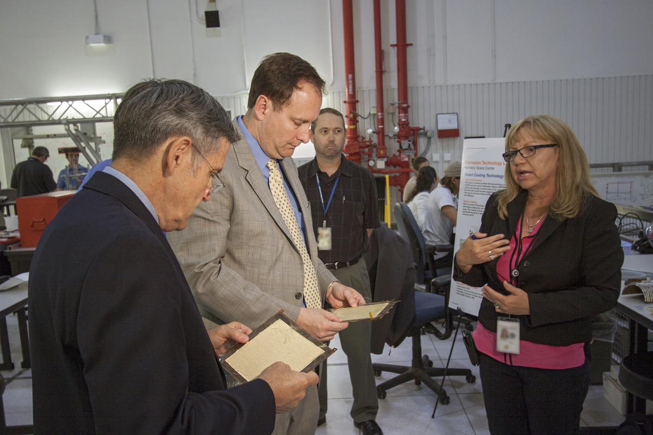 CAPE CANAVERAL, Fla. – At NASA’s Kennedy Space Center in Florida, Robert Lightfoot, NASA associate director, second from left, learns about smart coatings technology in the Corrosion Lab during a tour of the Swamp Works laboratories.   Kennedy’s Swamp Works provides rapid, innovative and cost-effective exploration mission solutions, leveraging partnerships across NASA, industry and academia. Kennedy’s research and technology mission is to improve spaceports on Earth, as well as lay the groundwork for establishing spaceports at destinations in space. For more information, visit http:__www.nasa.gov_centers_kennedy_exploration_researchtech_index.html. Photo credit: NASA_Jim Grossmann
