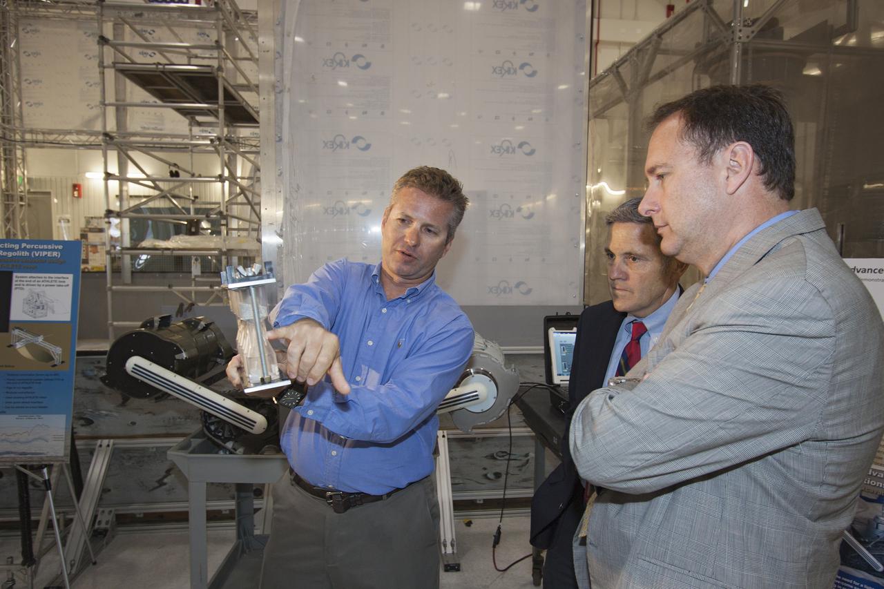 CAPE CANAVERAL, Fla. – At NASA’s Kennedy Space Center in Florida, Robert Lightfoot, NASA associate director, views some of the technologies in development at the center during a tour of the Swamp Works laboratories. Kennedy’s Swamp Works provides rapid, innovative and cost-effective exploration mission solutions, leveraging partnerships across NASA, industry and academia. Kennedy’s research and technology mission is to improve spaceports on Earth, as well as lay the groundwork for establishing spaceports at destinations in space. For more information, visit http:__www.nasa.gov_centers_kennedy_exploration_researchtech_index.html. Photo credit: NASA_Jim Grossmann