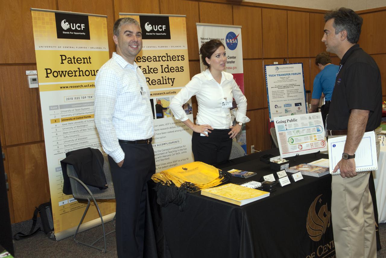CAPE CANAVERAL, Fla. -- At the Kennedy Space Center in Florida, representatives of the University of Central Florida talk with guests at the Innovation Expo KSC Showcase. The event gave Kennedy employees an opportunity to meet 12 NASA partners and see how the Center Planning and Development Directorate is transforming Kennedy into a multi-user spaceport through partnerships and resource planning. The 17-booth exhibit consists of 12 partner booths along with Spaceport Planning, Partnership Development and Research and Technology offices. Photo credit: NASA_Charisse Nahser