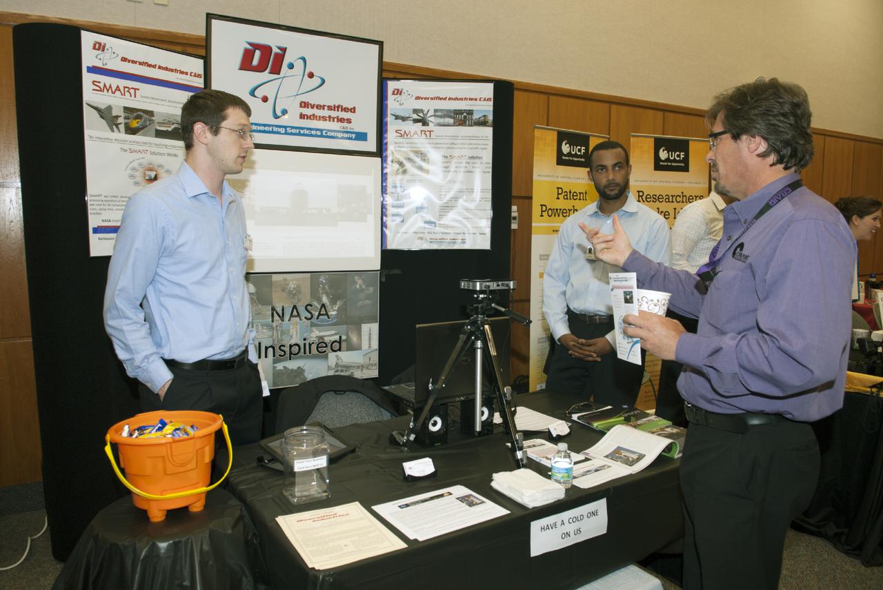 CAPE CANAVERAL, Fla. -- At the Kennedy Space Center in Florida, representatives of Diversified Industries talk with guests at the Innovation Expo KSC Showcase. The event gave Kennedy employees an opportunity to meet 12 NASA partners and see how the Center Planning and Development Directorate is transforming Kennedy into a multi-user spaceport through partnerships and resource planning. The 17-booth exhibit consists of 12 partner booths along with Spaceport Planning, Partnership Development and Research and Technology offices. Photo credit: NASA_Charisse Nahser