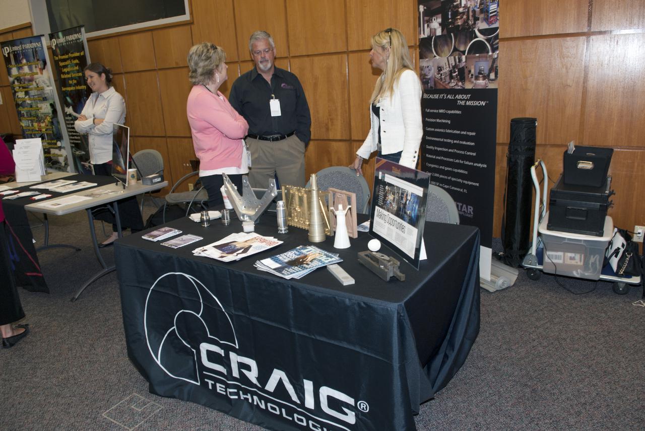 CAPE CANAVERAL, Fla. -- At the Kennedy Space Center in Florida, representatives of Craig Technologies talk with guests at the Innovation Expo KSC Showcase. The event gave Kennedy employees an opportunity to meet 12 NASA partners and see how the Center Planning and Development Directorate is transforming Kennedy into a multi-user spaceport through partnerships and resource planning. The 17-booth exhibit consists of 12 partner booths along with Spaceport Planning, Partnership Development and Research and Technology offices. Photo credit: NASA_Charisse Nahser