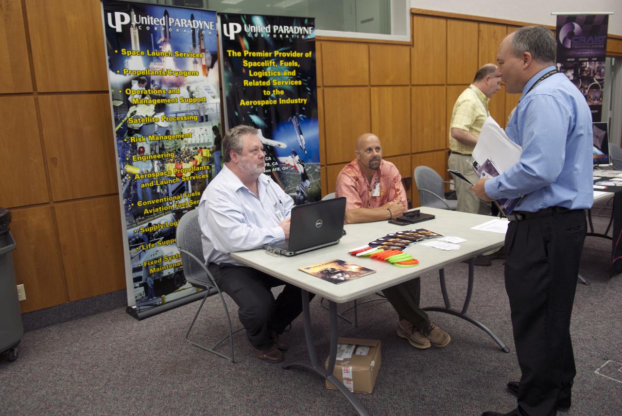 CAPE CANAVERAL, Fla. -- At the Kennedy Space Center in Florida, representatives of United Paradyne talk with guests at the Innovation Expo KSC Showcase. The event gave Kennedy employees an opportunity to meet 12 NASA partners and see how the Center Planning and Development Directorate is transforming Kennedy into a multi-user spaceport through partnerships and resource planning. The 17-booth exhibit consists of 12 partner booths along with Spaceport Planning, Partnership Development and Research and Technology offices. Photo credit: NASA_Charisse Nahser