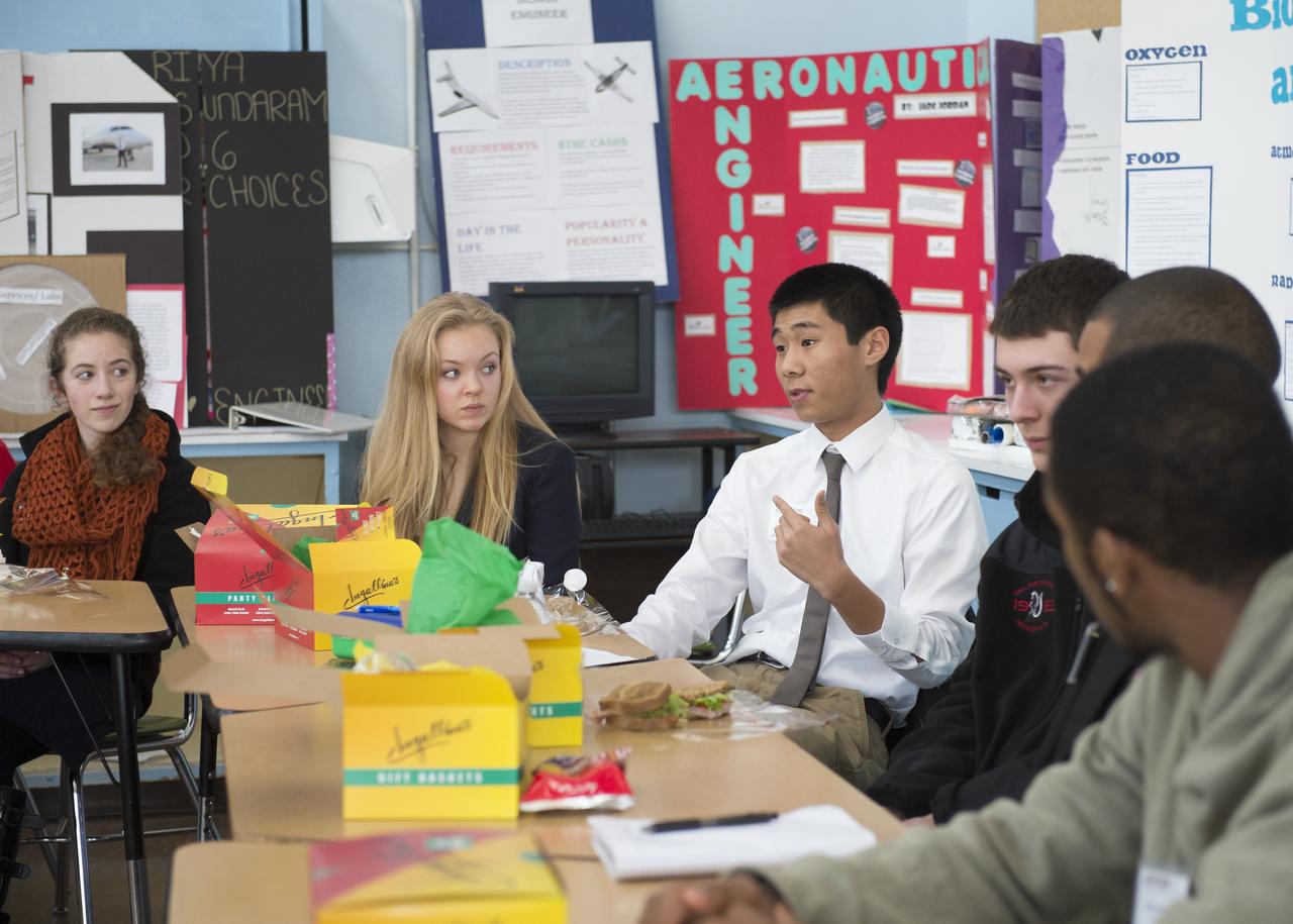 Chris Lu (third from left), a student at Aviation High School, asks a question at a lunch and learn session with NASA Administrator Charles Bolden, Tuesday, Jan. 15, 2013 in Des Moines, WA.  Aviation High School is a college preparatory aviation- and aerospace-themed school and a premier school of choice for science, technology, engineering and math (STEM) in the Pacific Northwest.  Photo Credit: (NASA/Carla Cioffi)