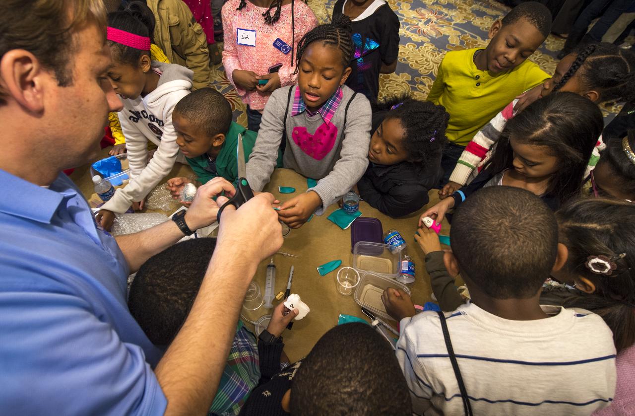 School children are taught to build their own spacecraft and habitat during a Science, Technology, Engineering, and Math (STEM) education event held at the Ritz-Carlton Hotel in Arlington, VA on Saturday, Jan. 19, 2013.  Students were able to meet with Astronaut Leland Melvin, conduct experiments, build their own space jab, and touch a mockup space suit.  Photo Credit: (NASA/Bill Ingalls)