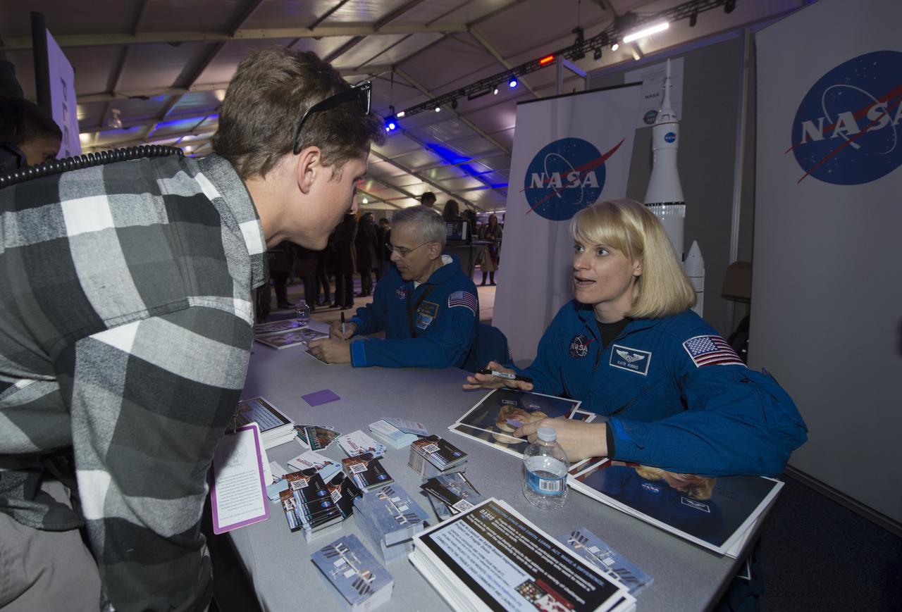NASA Astronaut Kate Rubins signs autographs at the NASA booth set up on the National Mall as part of the National Day of Service, Saturday, January 19, 2013, in Washington.  NASA along with other federal agencies set up along the Mall as part of events surrounding the inauguration of President Barack Obama. Photo Credit: (NASA/Carla Cioffi)
