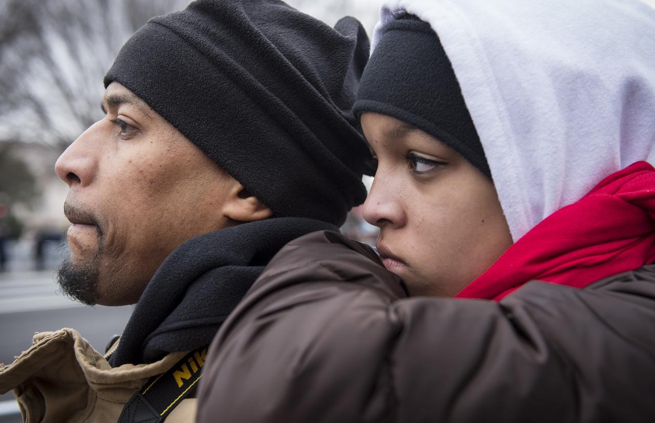 Ken Wheeler and his daughter Kayla listen intently to President Barack Obama's speech following his swearing in as they stand along Pennsylvania Avenue in Washington, Monday, Jan. 21, 2013. The Wheeler's traveled from Cincinnati, Ohio to attend the event. Photo Credit: (NASA/Paul E. Alers)