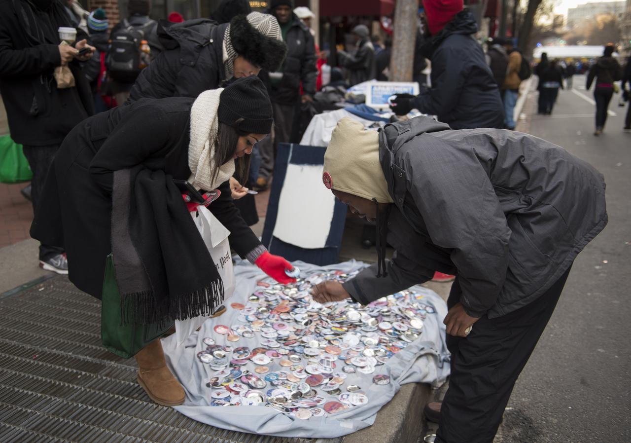 Parade goers shop for souvenirs from a street vendor prior to the swearing in ceremony of President Barack Obama, Monday, Jan. 21, 2013, in Washington. Street vendors lined the streets of Washington, Monday to commemorate the nation's 44th President. Photo Credit: (NASA/Paul E. Alers)