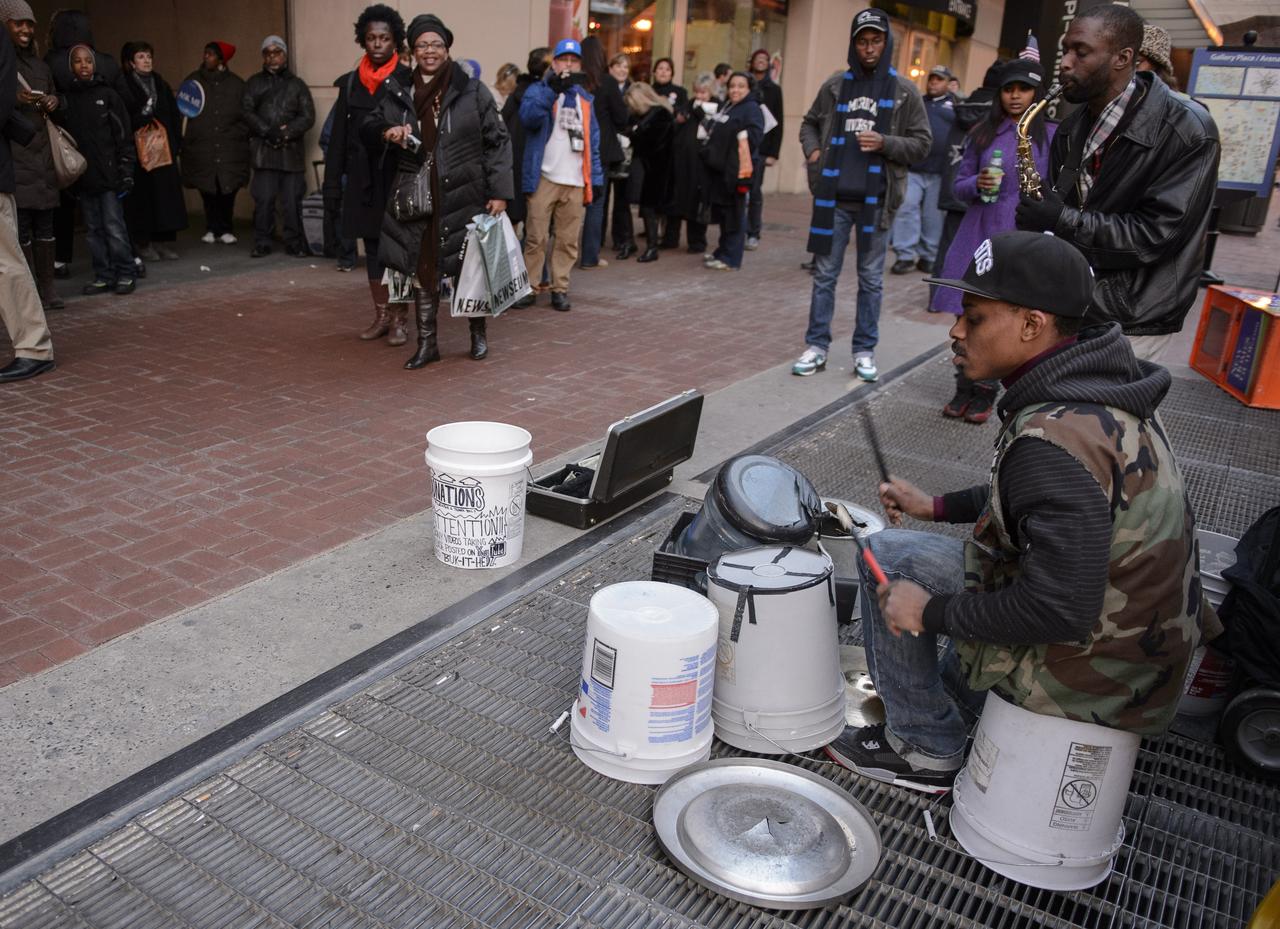 Parade goers enjoy the music of street musicians outside a metro stop after attending the inaugural parade honoring  President Barack Obama, Monday, Jan. 21, 2013, in Washington. Photo Credit: (NASA/Paul E. Alers)