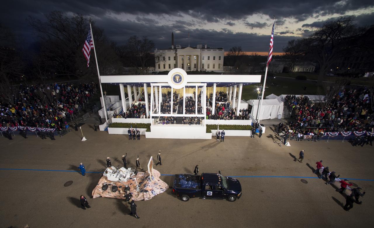 A replica of NASA's Curiosity Rover and members of the Mars Science Laboratory (MSL) science team pass the Presidential viewing stand and President Barack Obama during the inaugural parade honoring Obama, Monday Jan. 21, 2013, in Washington. Obama was sworn-in as the nation's 44th President earlier in the day. Photo Credit: (NASA/Bill Ingalls)