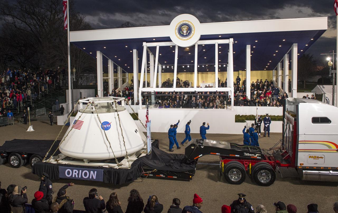The Orion space capsule along with NASA Astronauts Lee Morin, Alvin Drew, Kjell Lindgren, Serena Aunon, Kate Rubins, and Mike Massimino pass the Presidential viewing stand and President Barack Obama during the inaugural parade honoring Obama, Monday Jan. 21, 2013, in Washington. Obama was sworn-in as the nation's 44th President earlier in the day. Photo Credit: (NASA/Bill Ingalls)